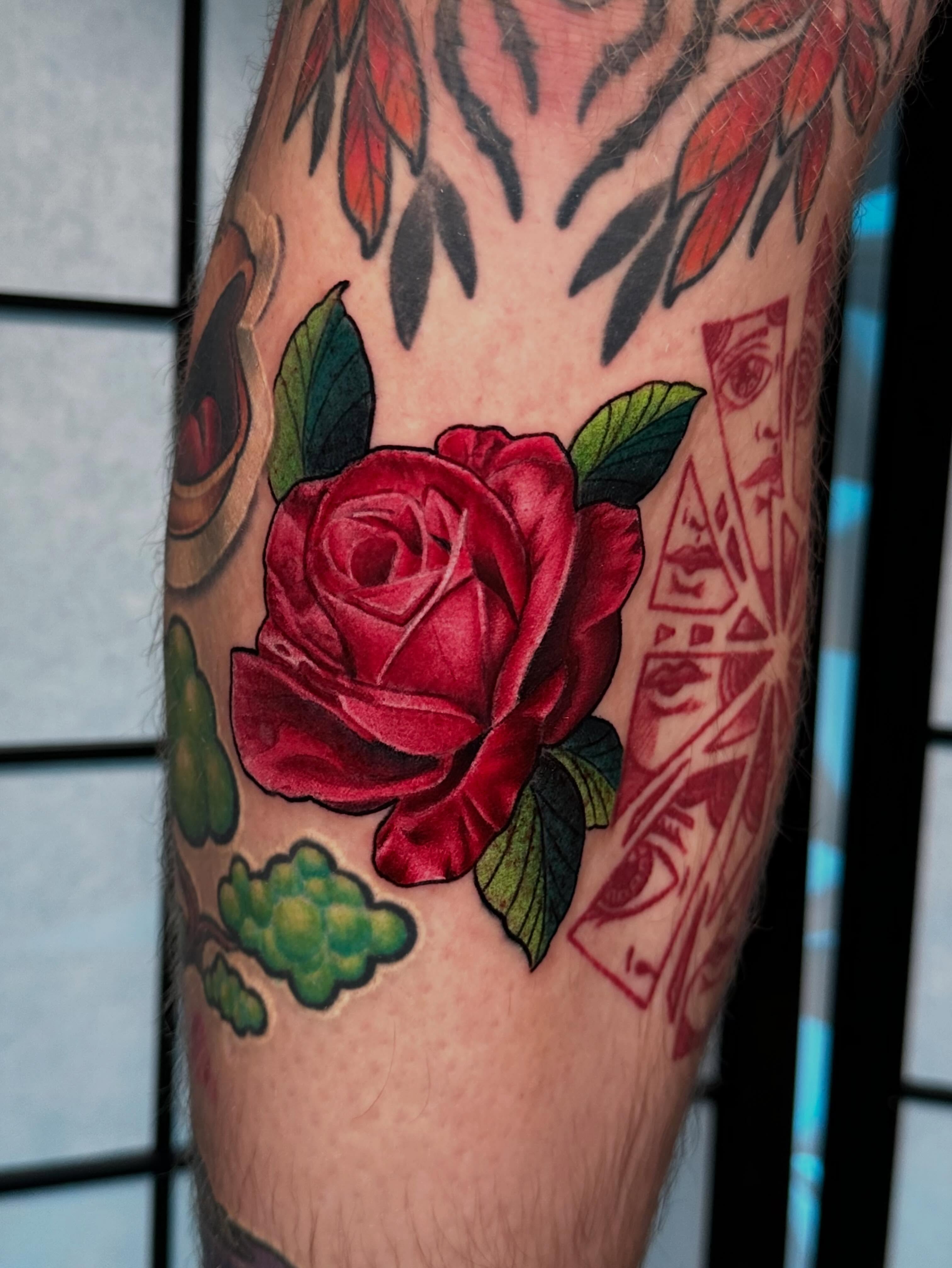 Red rose realism tattoo on the forearm by Chi, Charlotte, North Carolina