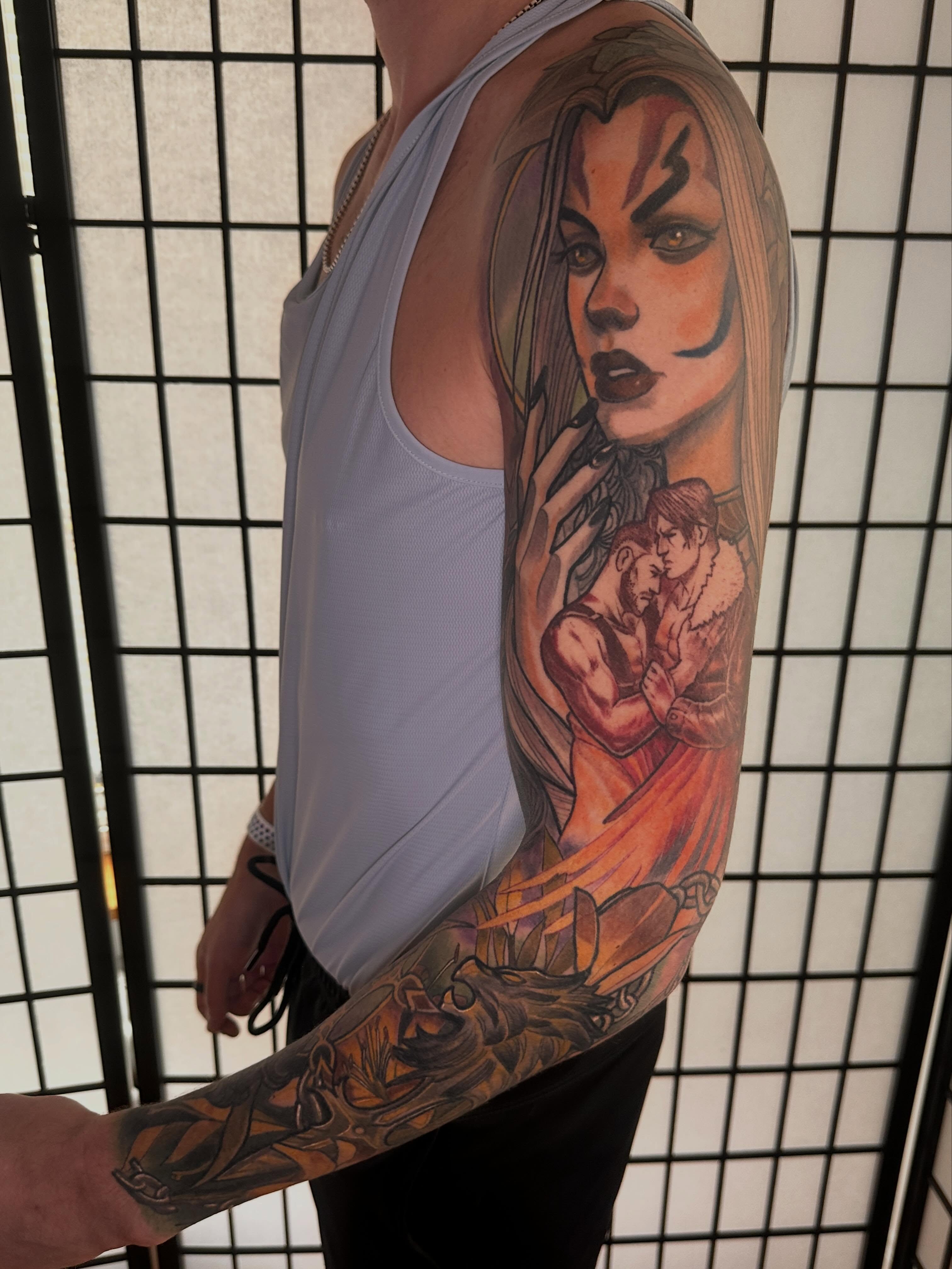 Woman with two men realism tattoo on the upper arm by Javier Rivera