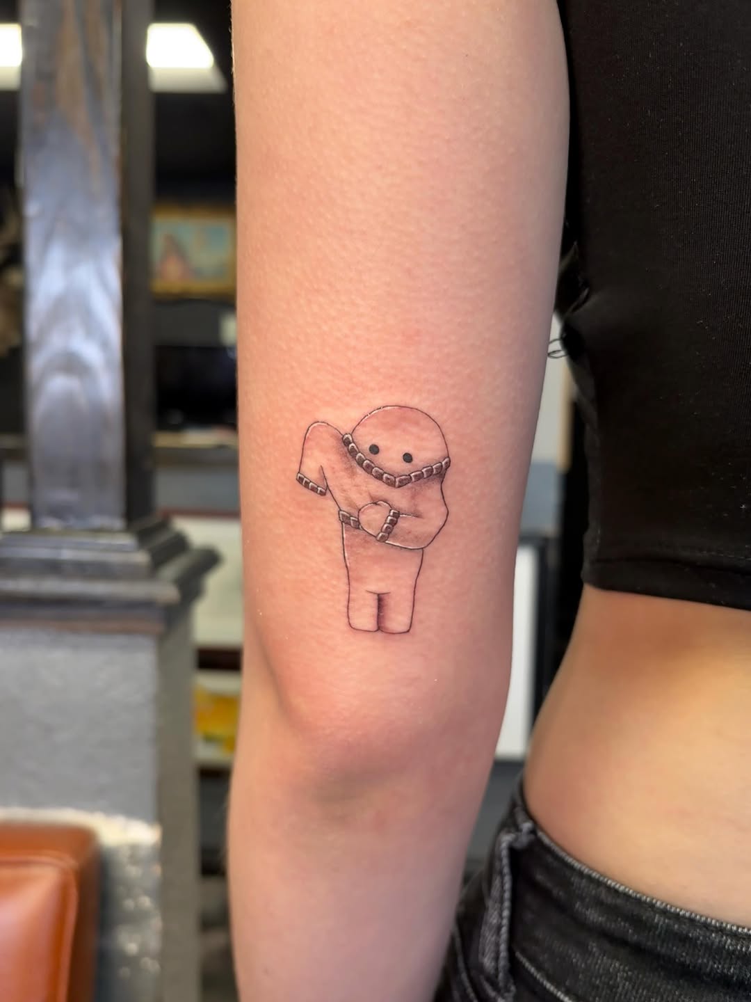 Cartoon character with blanket new school tattoo on the forearm by alana khounmeuang