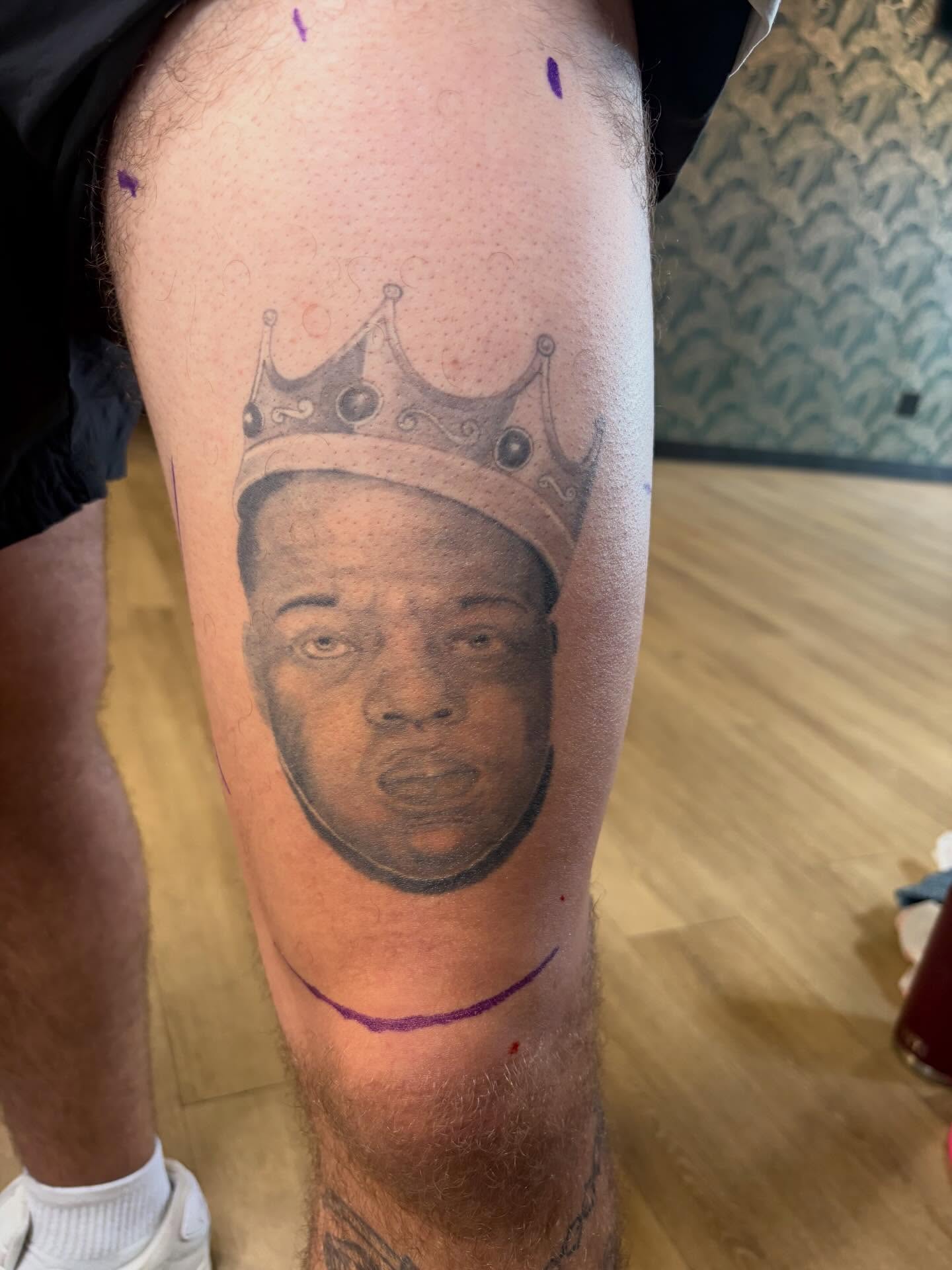 Portrait with crown realism tattoo on the thigh by Scrap Iron Tattoos