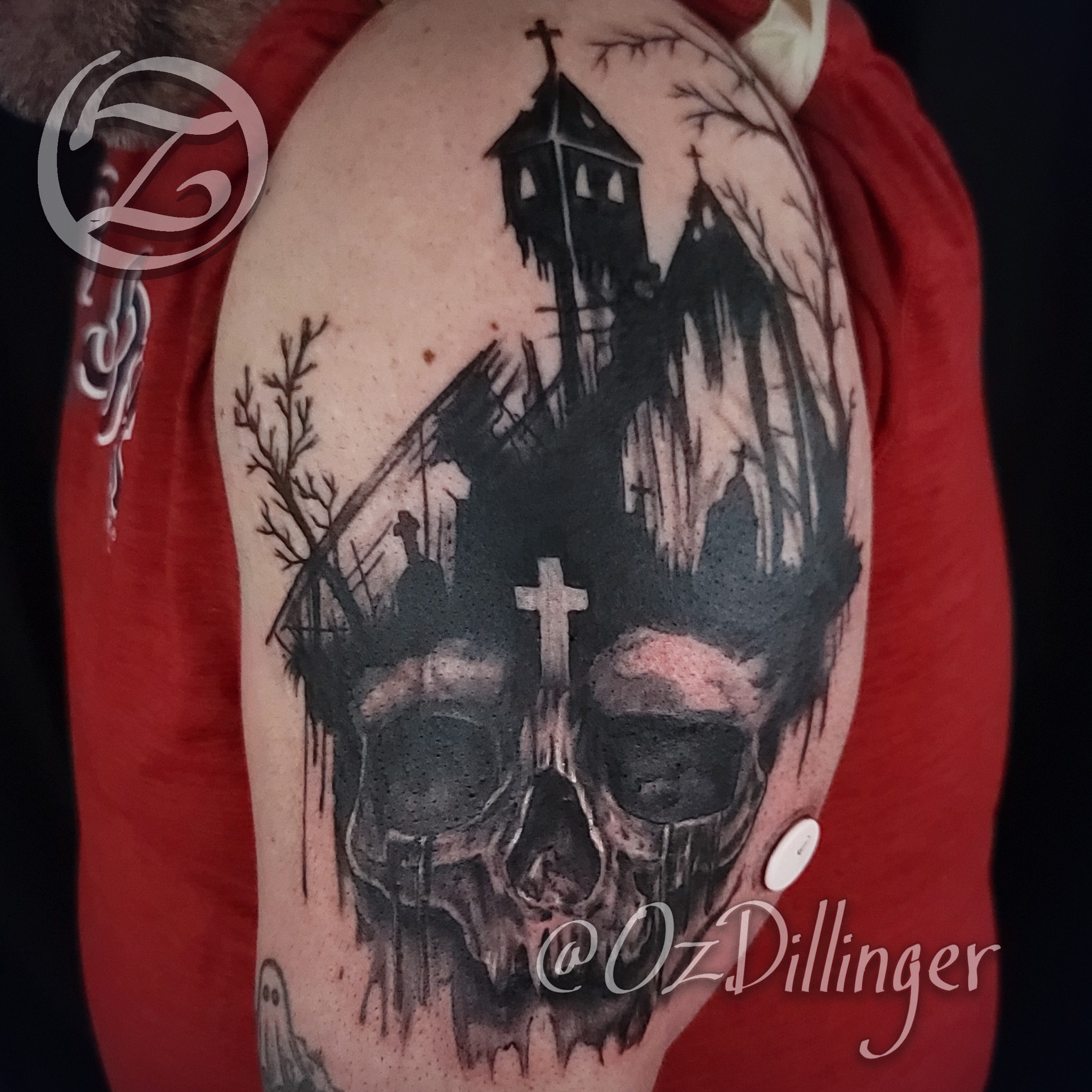 Skull and haunted house dark realism tattoo on the shoulder by Oz Dillinger
