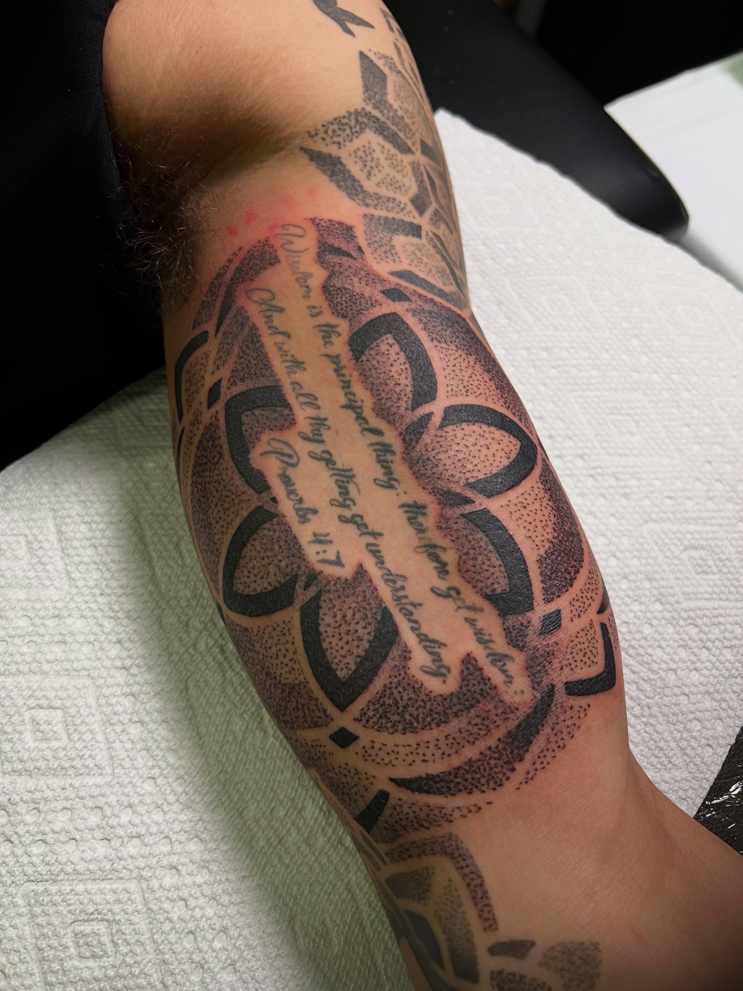 Script lettering dotwork tattoo on the forearm by Riley