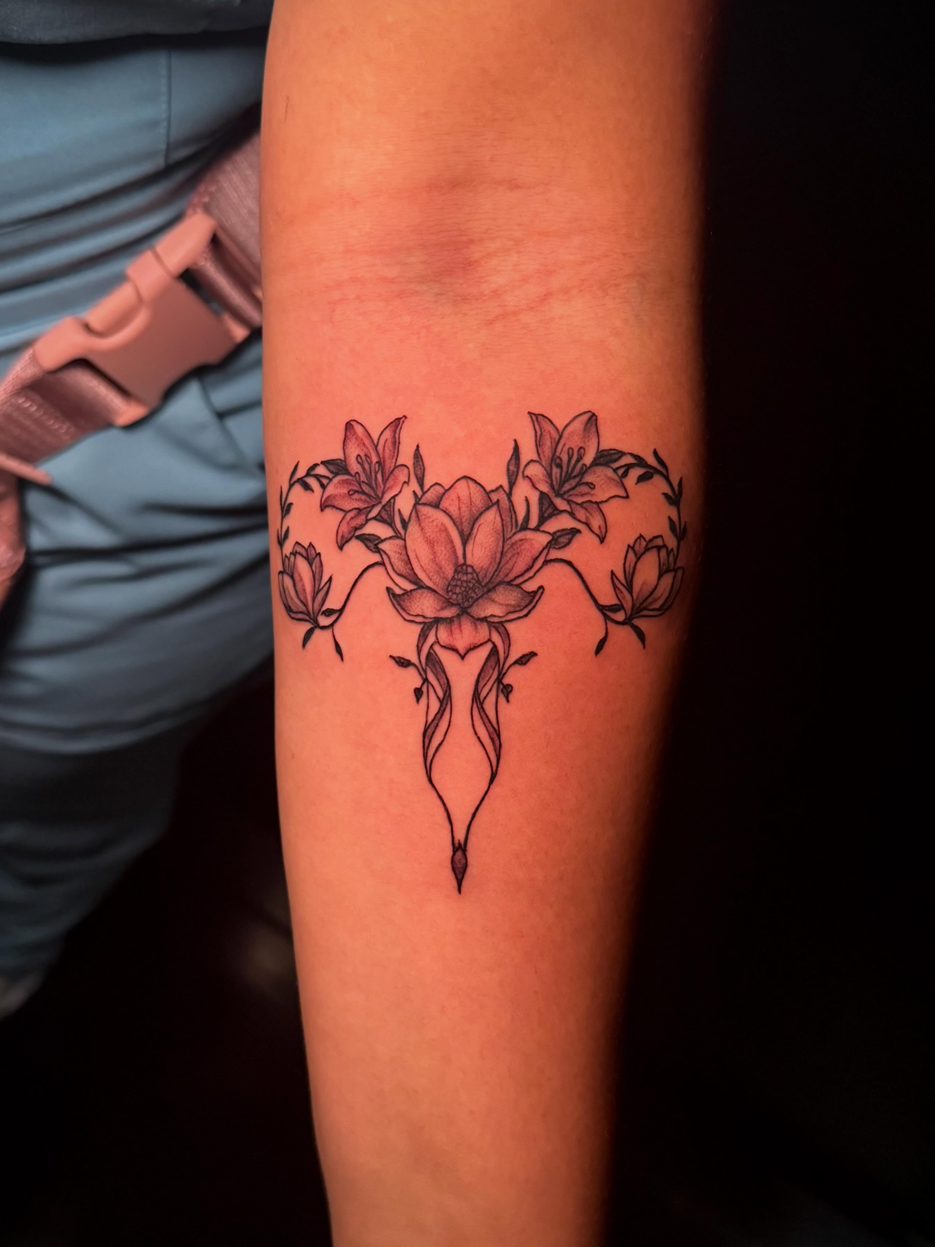 Uterus with flowers black and grey tattoo on the forearm by π΅ππππππ¦π€