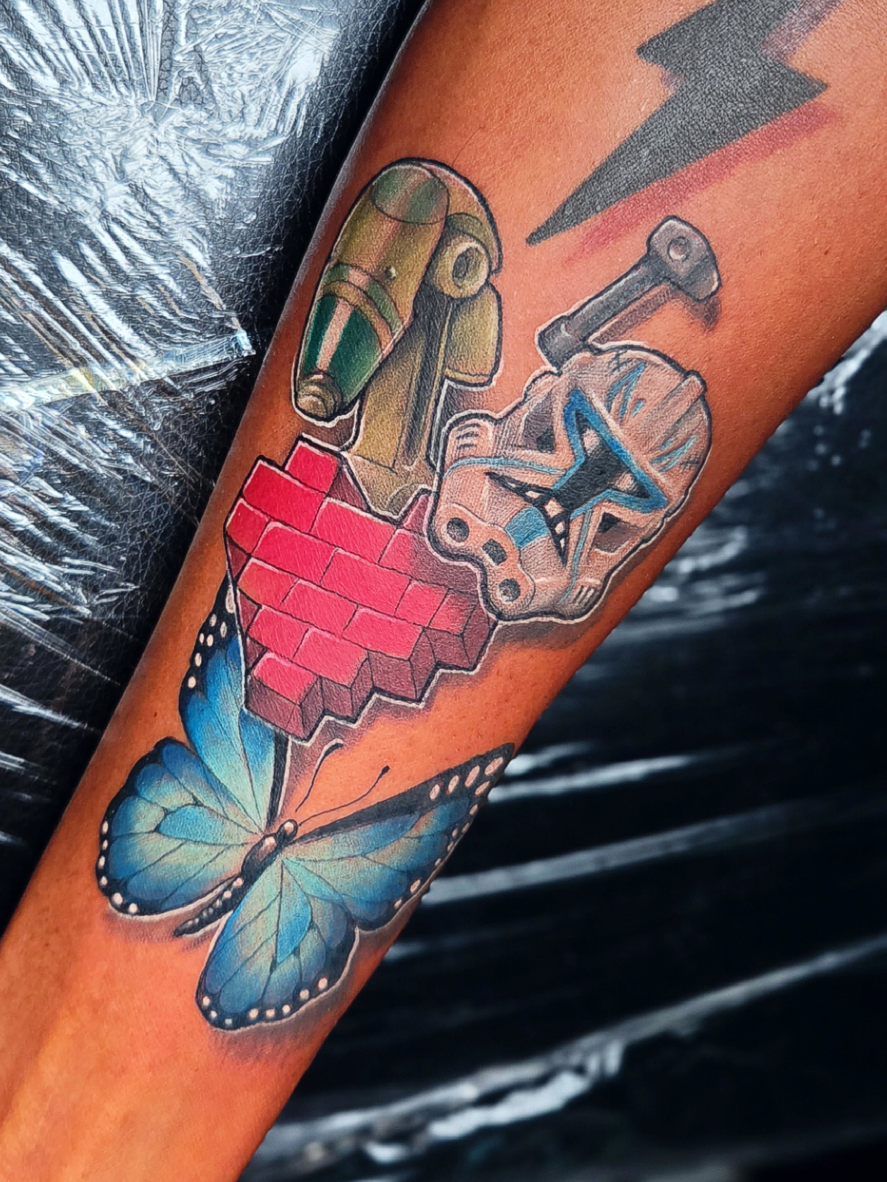 Robotic heart with butterfly dotwork tattoo on the forearm by ๐๐๐๐
