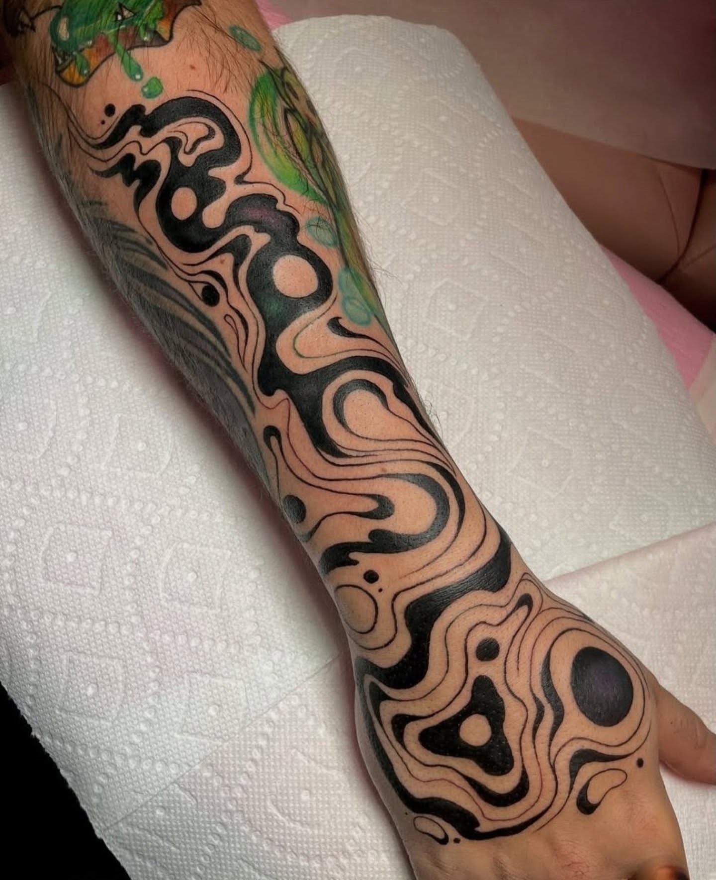 Abstract wave pattern black and grey tattoo on the forearm by Chloe Marie