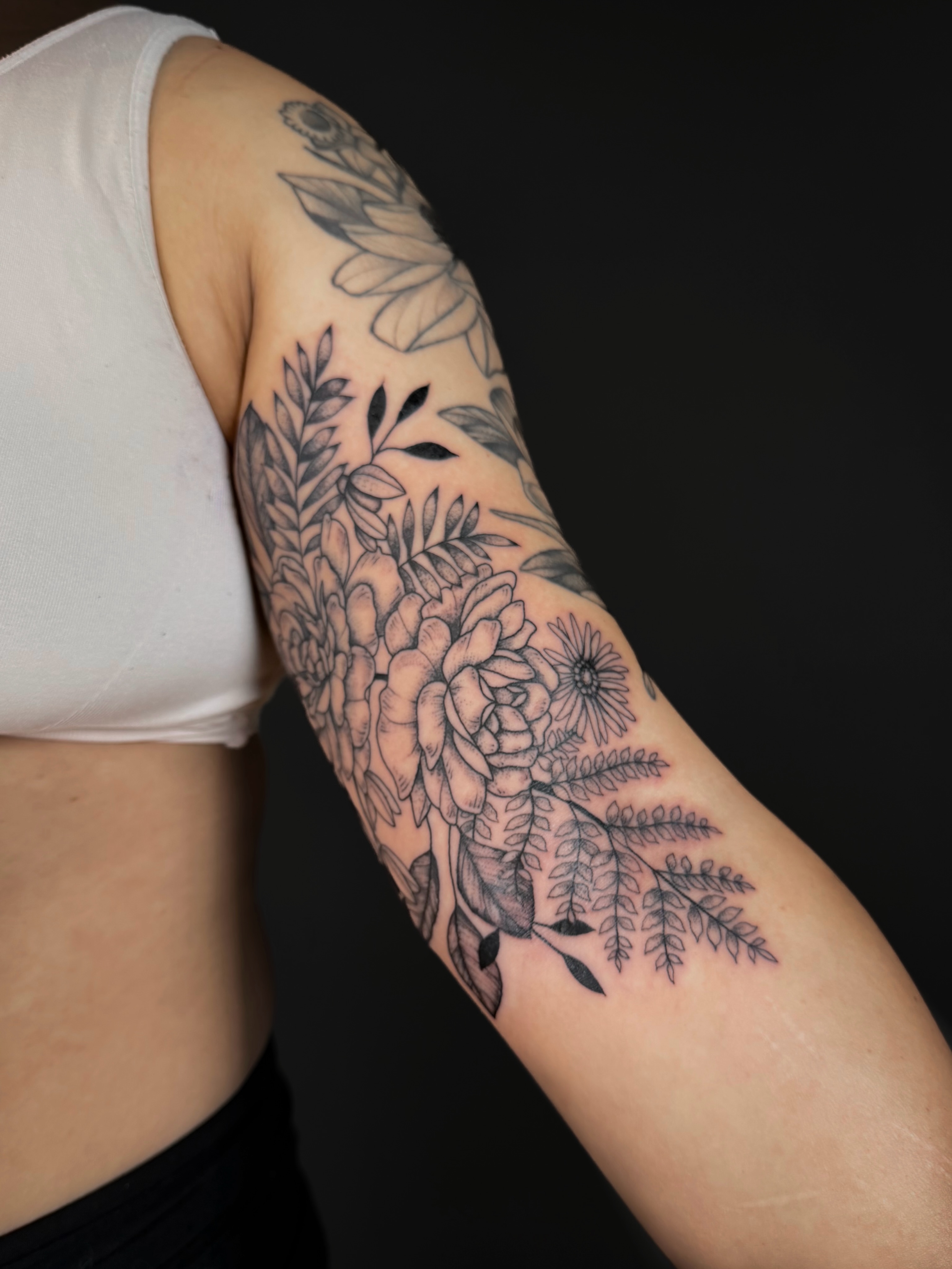 Floral bouquet black and grey tattoo on the forearm by Hannah, Portland, Oregon
