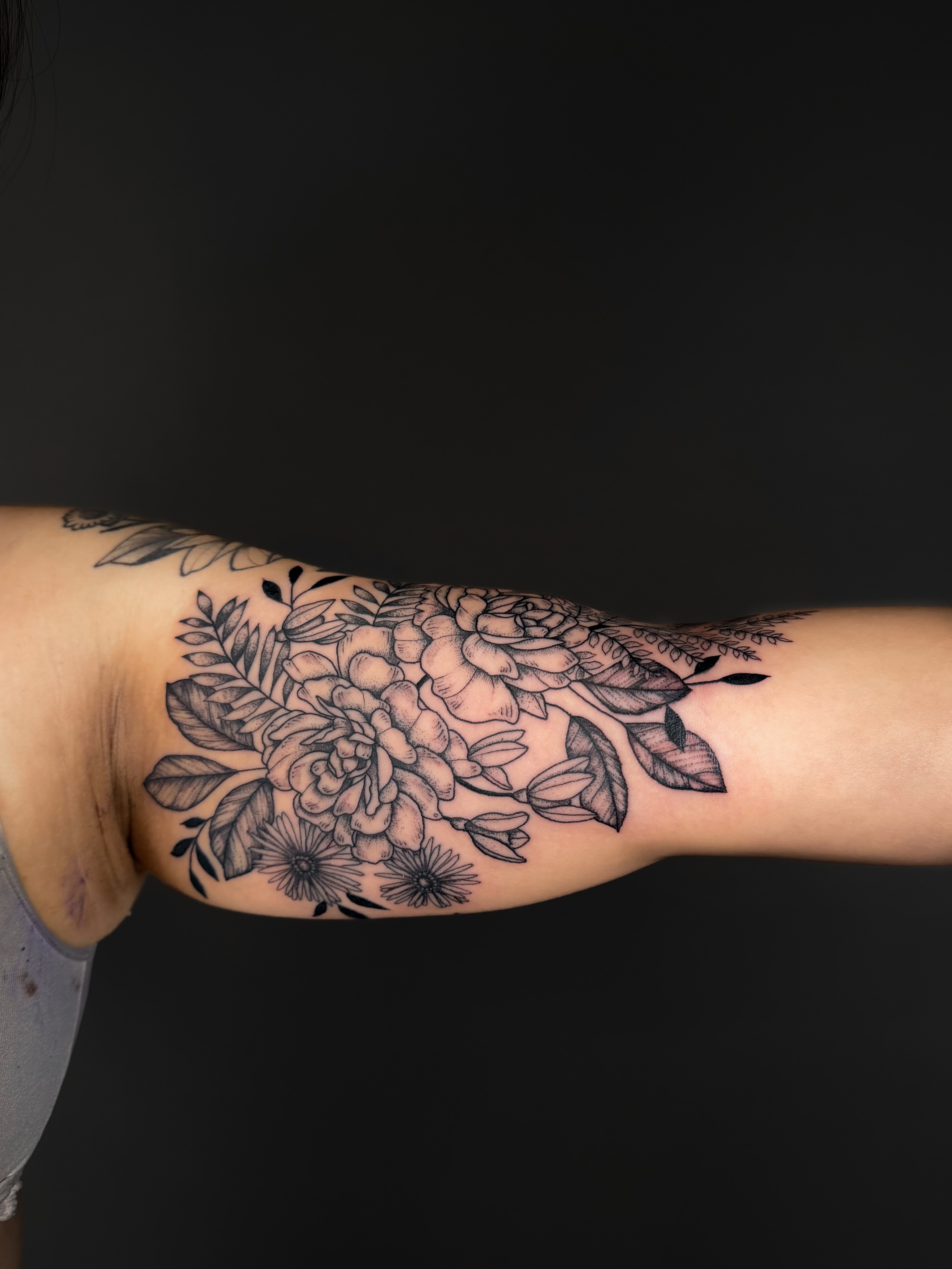 Floral bouquet black and grey tattoo on the forearm by Hannah, Portland, Oregon