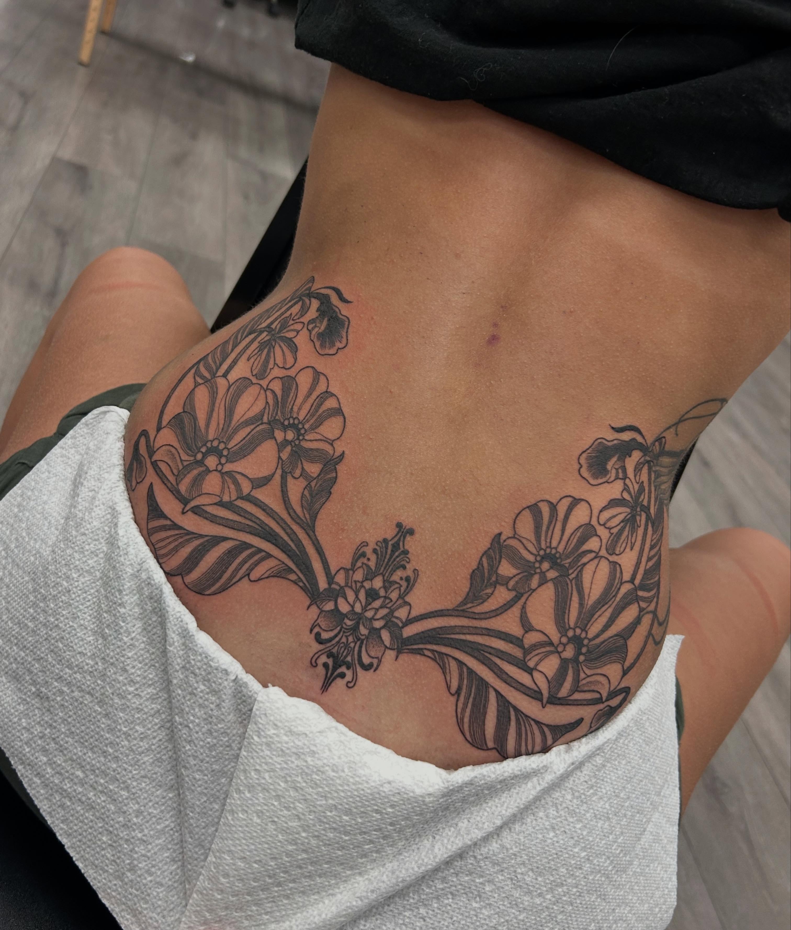Floral design black and grey tattoo on the torso by Livy baby