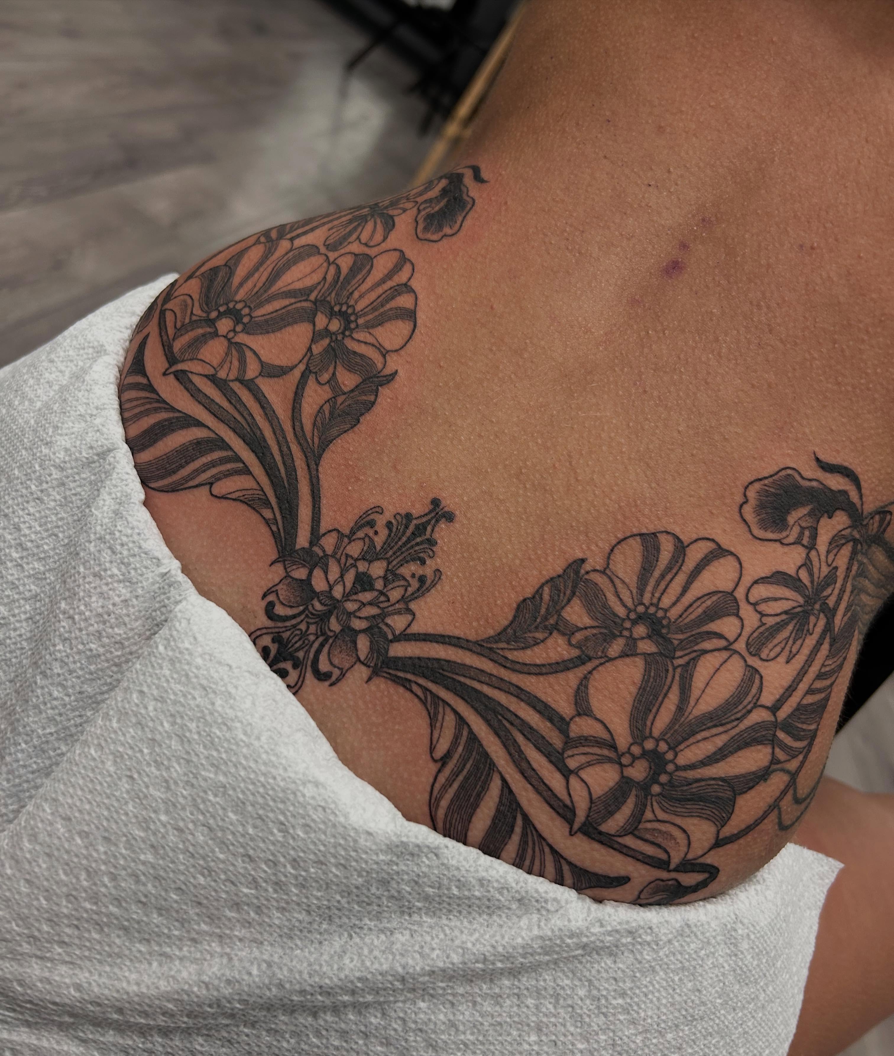 Floral design black and grey tattoo on the shoulder by Livy baby