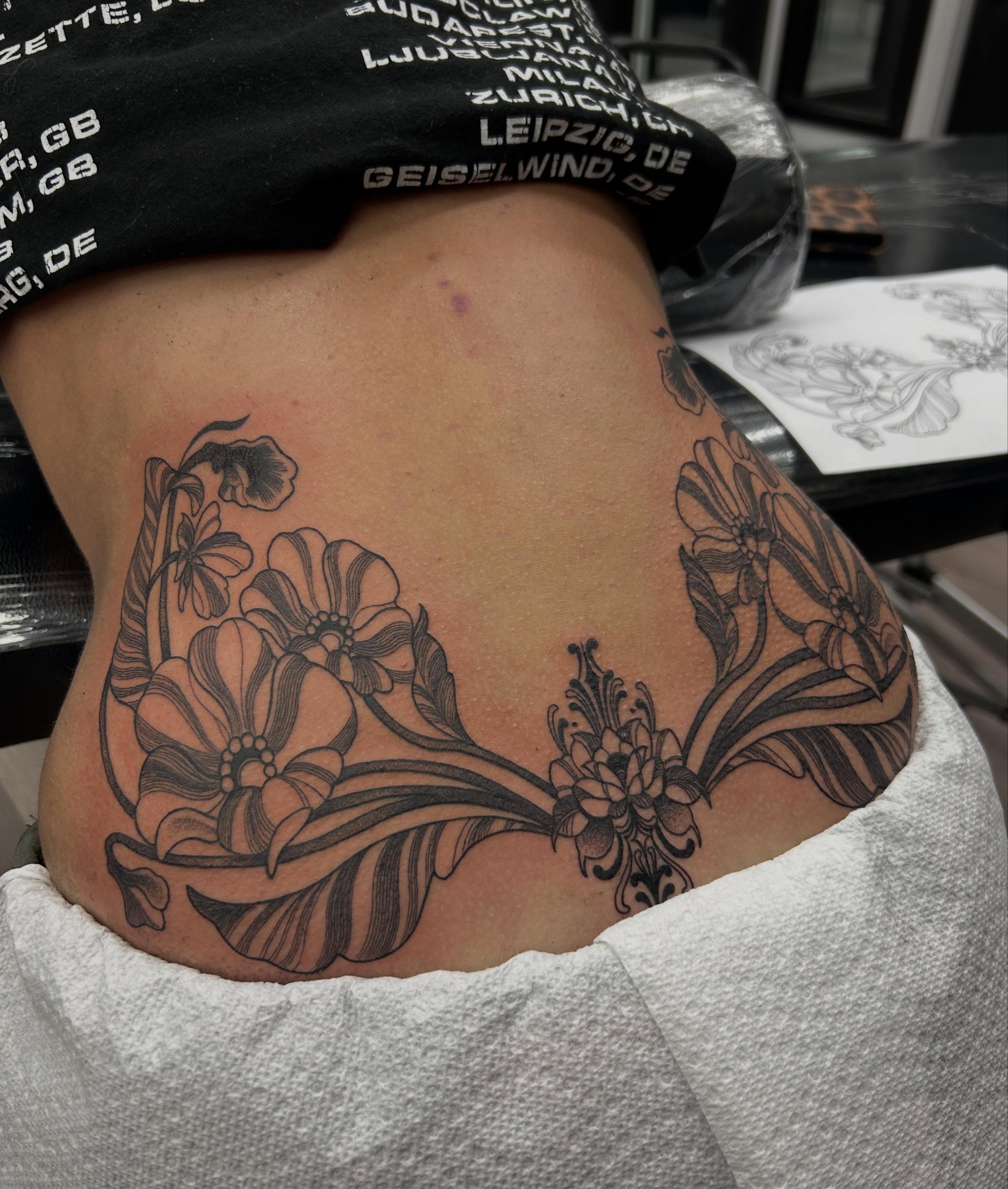 Floral arrangement black and grey tattoo on the torso by Livy baby