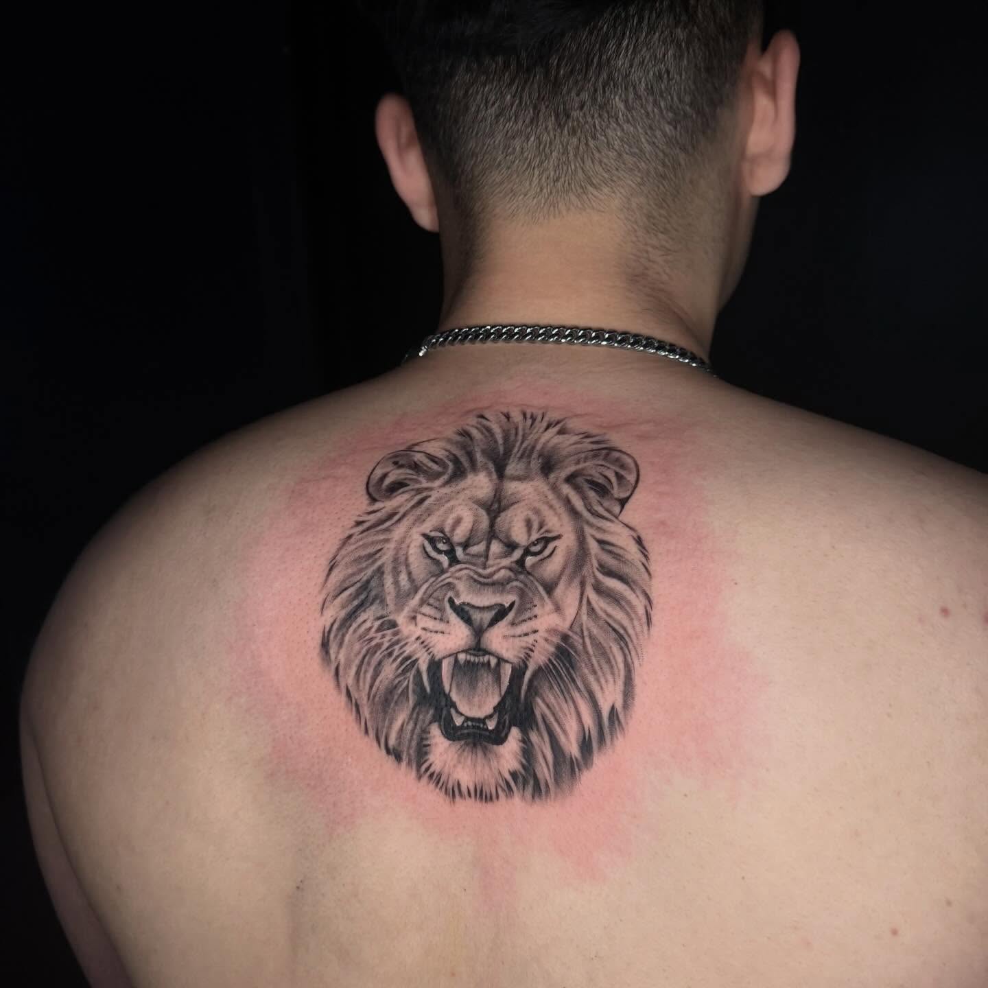 Lion realism tattoo on the back by Angela Azure