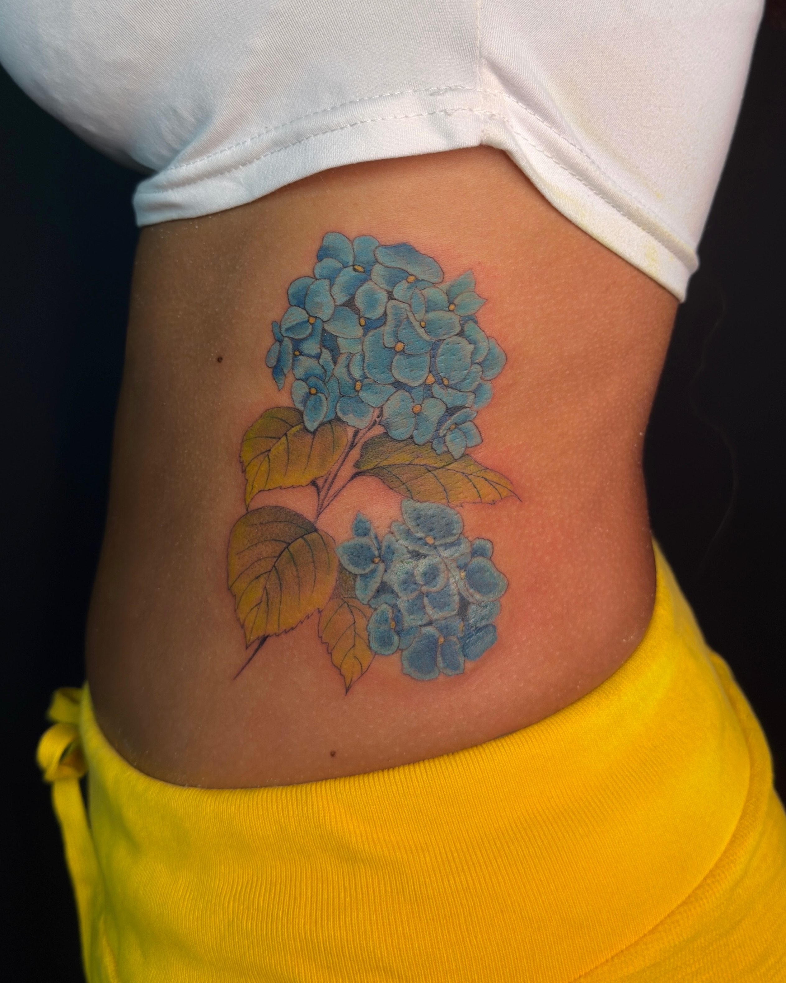 Hydrangea bouquet realism tattoo on the torso by Vu Nguyen