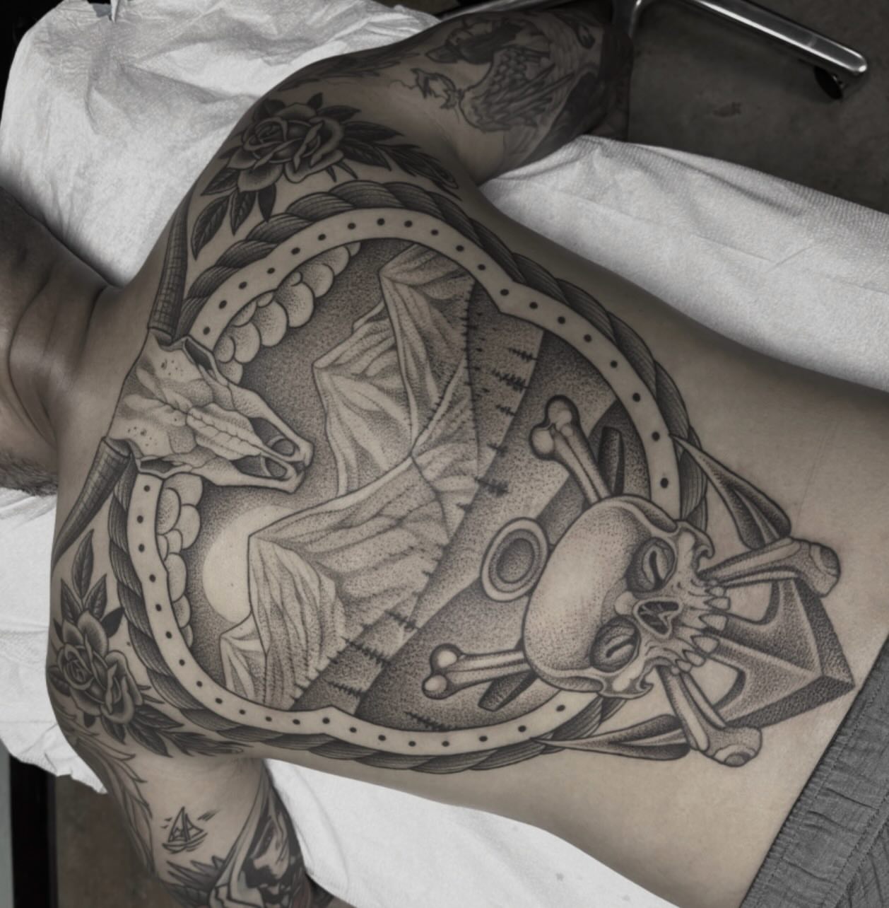 Skull and crossbones dotwork tattoo on the thigh by Austin Tattoo Artist