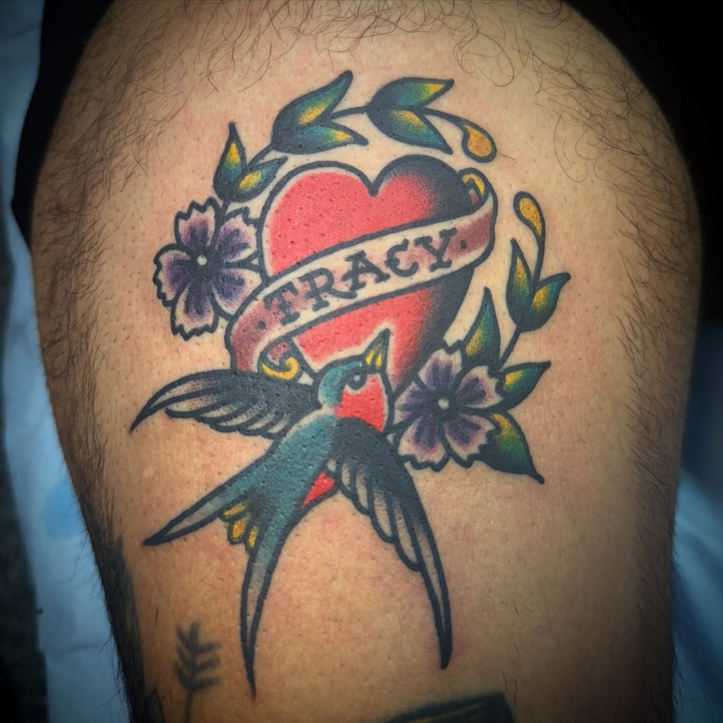 Heart with name American traditional tattoo on the thigh by Chuck Paprocki, Nashville, Tennessee