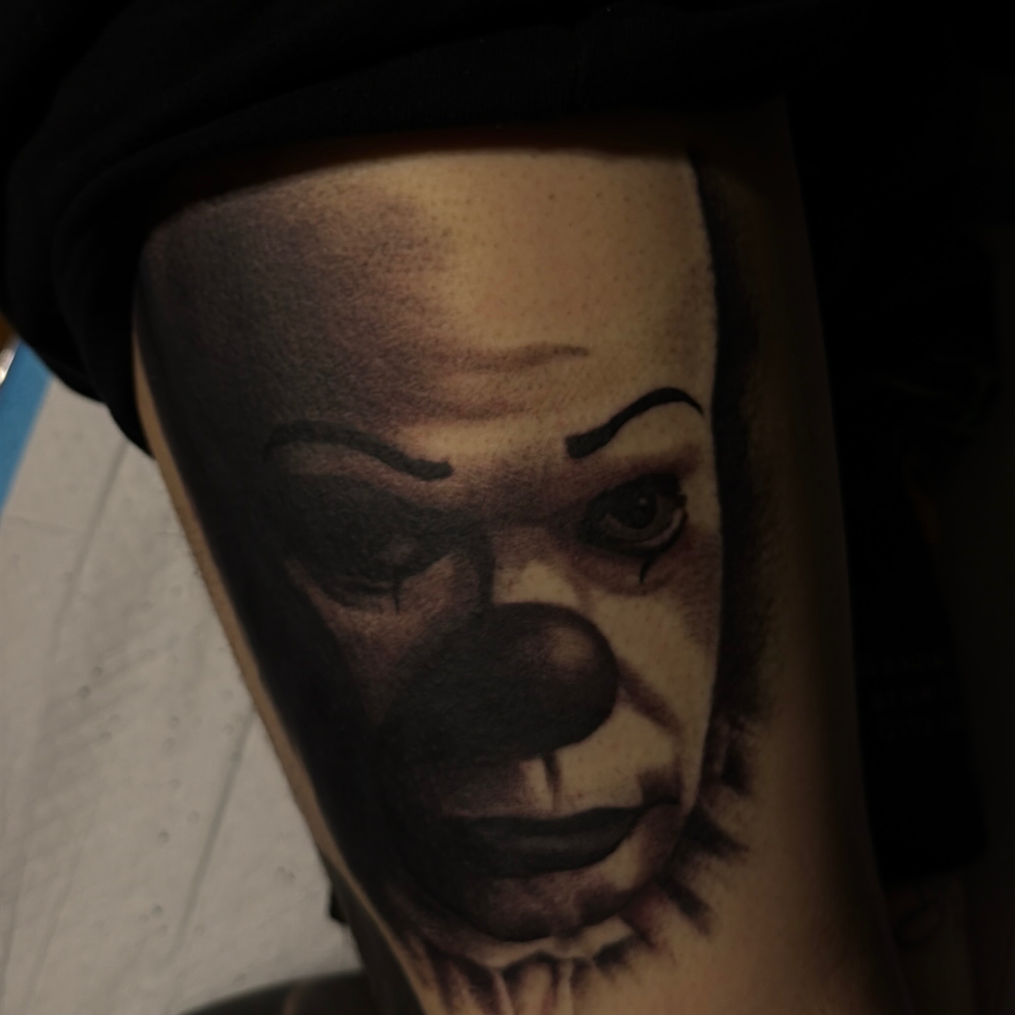 Clown face realism tattoo on the forearm by Nick Campbell