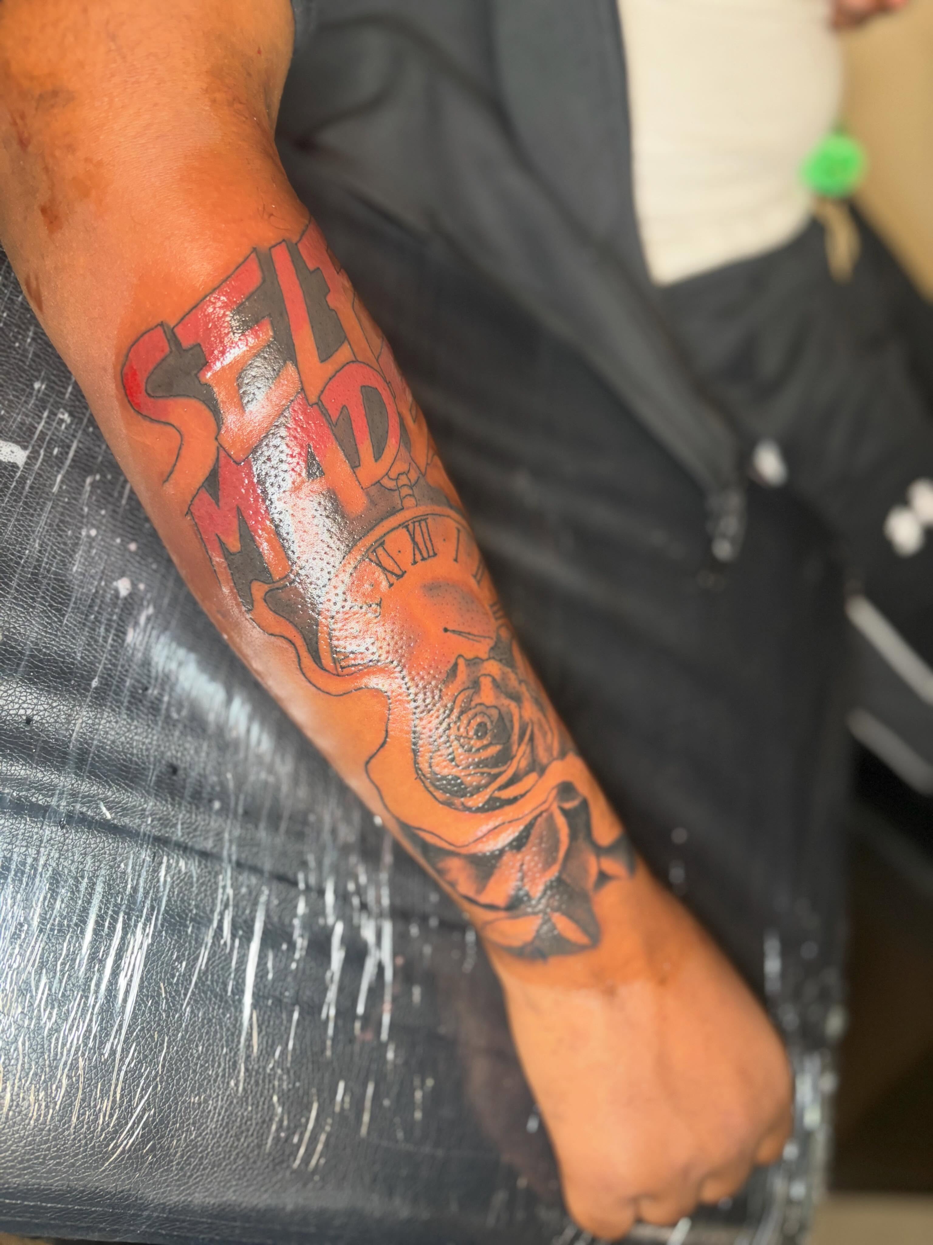 Self-made clock with rose dotwork tattoo on the forearm by Mr.K