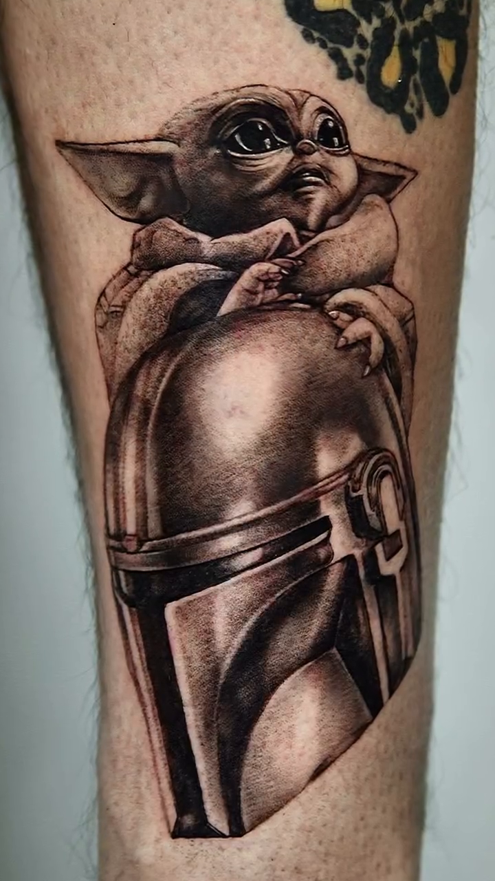 Grogu on Mandalorian helmet realism tattoo by Milk Tattoos 🇸🇻🇪🇸