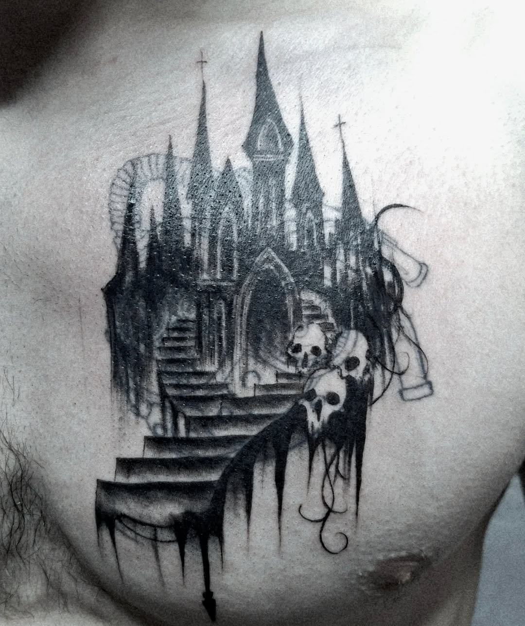 Gothic castle with skulls dark art tattoo on the chest by hallowed girl tattoo