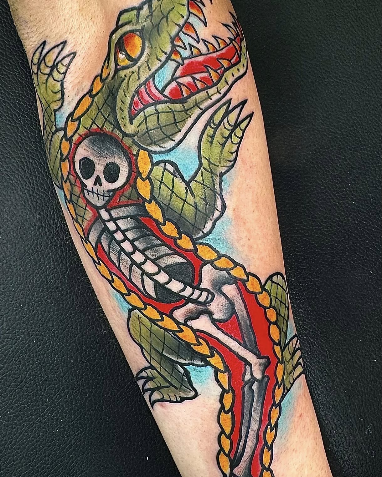 Dragon and skeleton American traditional tattoo on the forearm by Dave Robinowitz