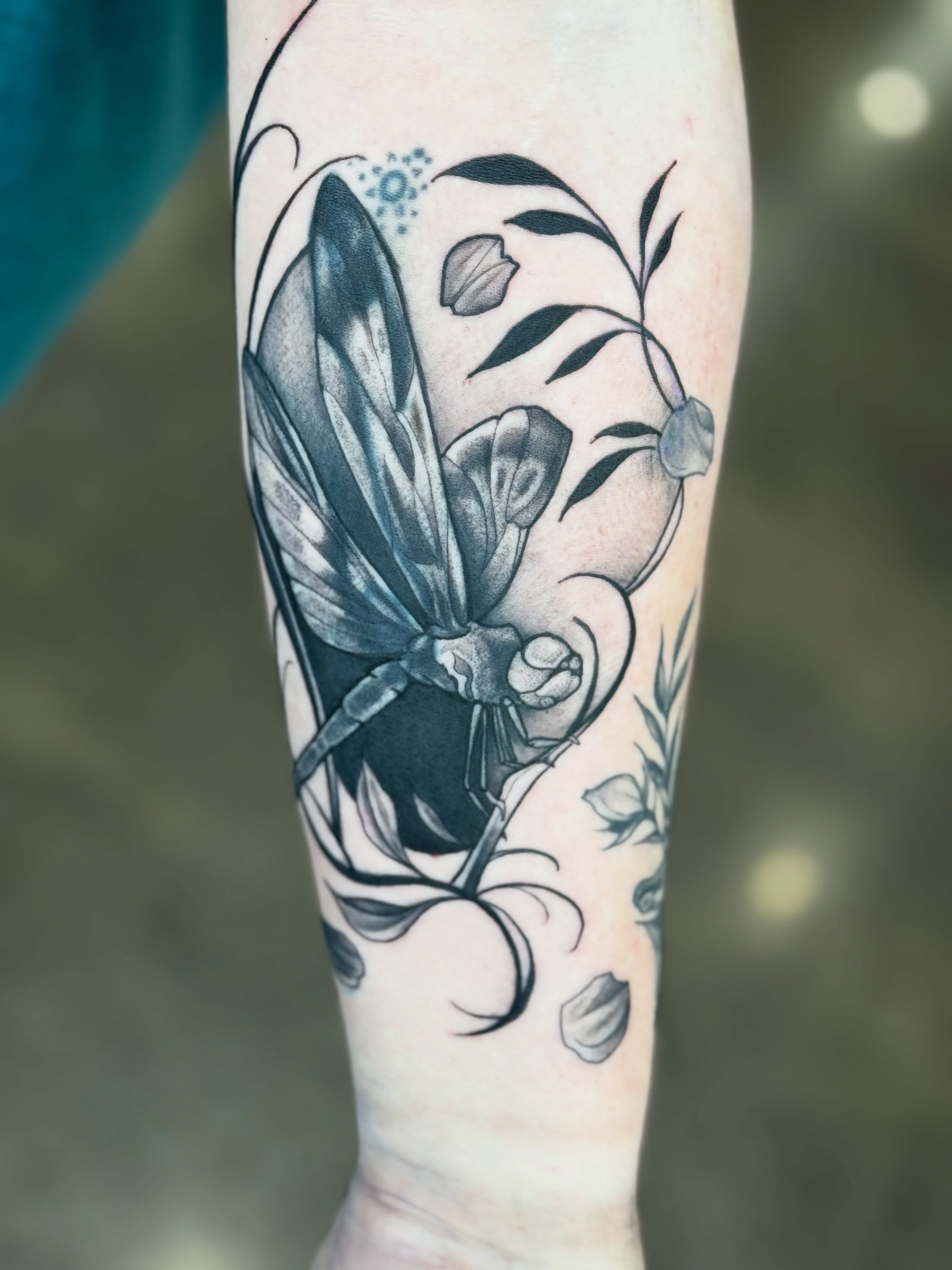 Insect and floral realism tattoo on the forearm by Glory Pechonis πΏ
