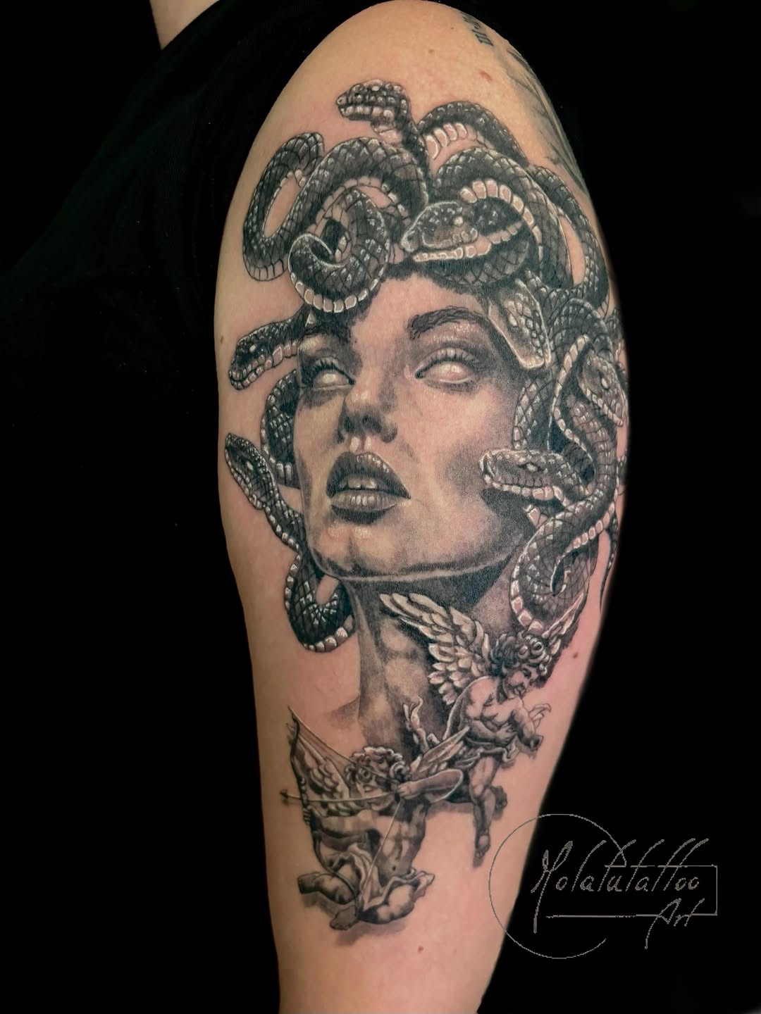Medusa with snakes and cherubs realism tattoo on the shoulder by Molatutattoo