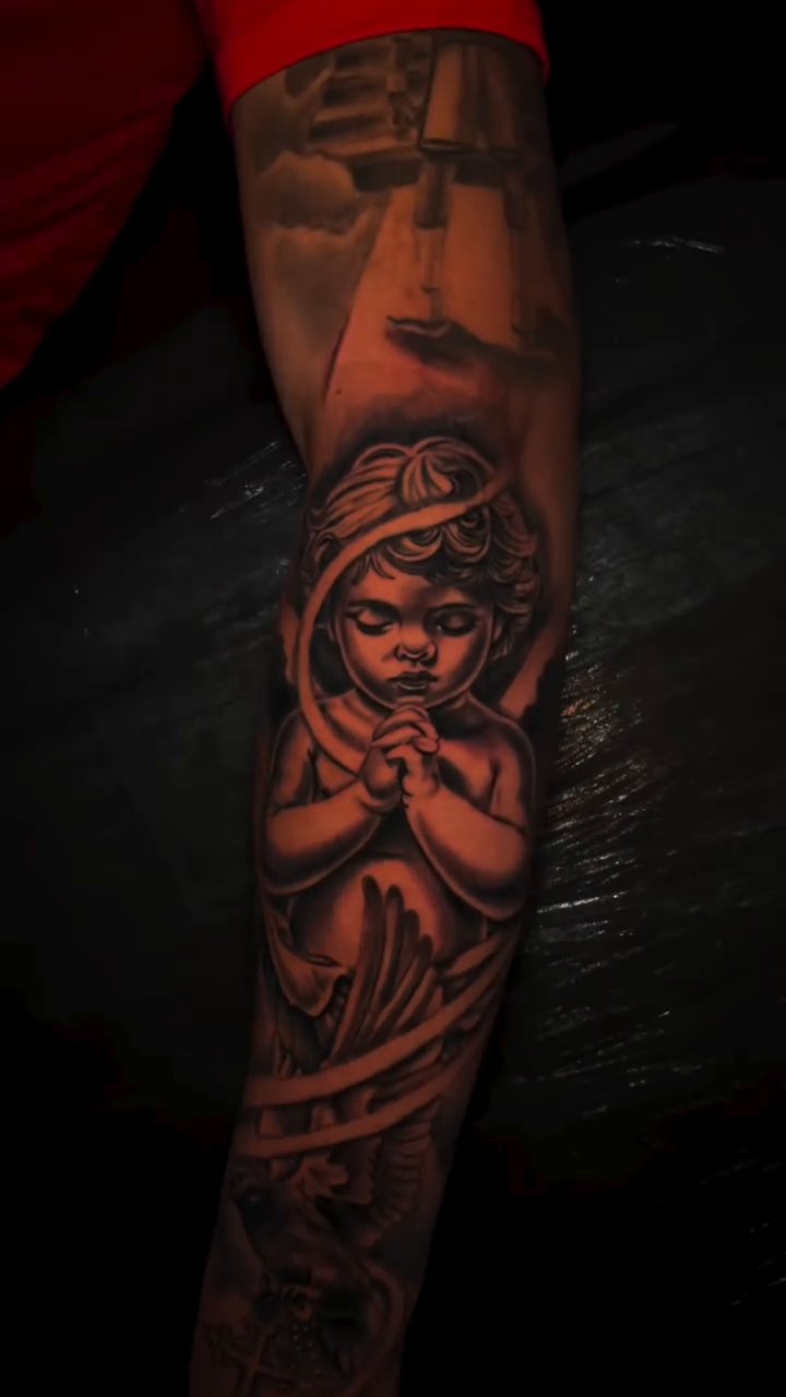 Cherub with praying hands realism tattoo by Lucky Lefty