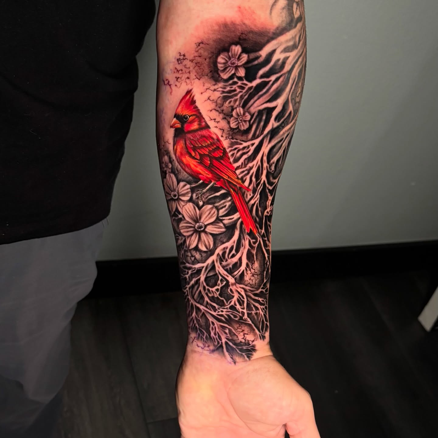 Cardinal bird realism tattoo on the forearm by Dave