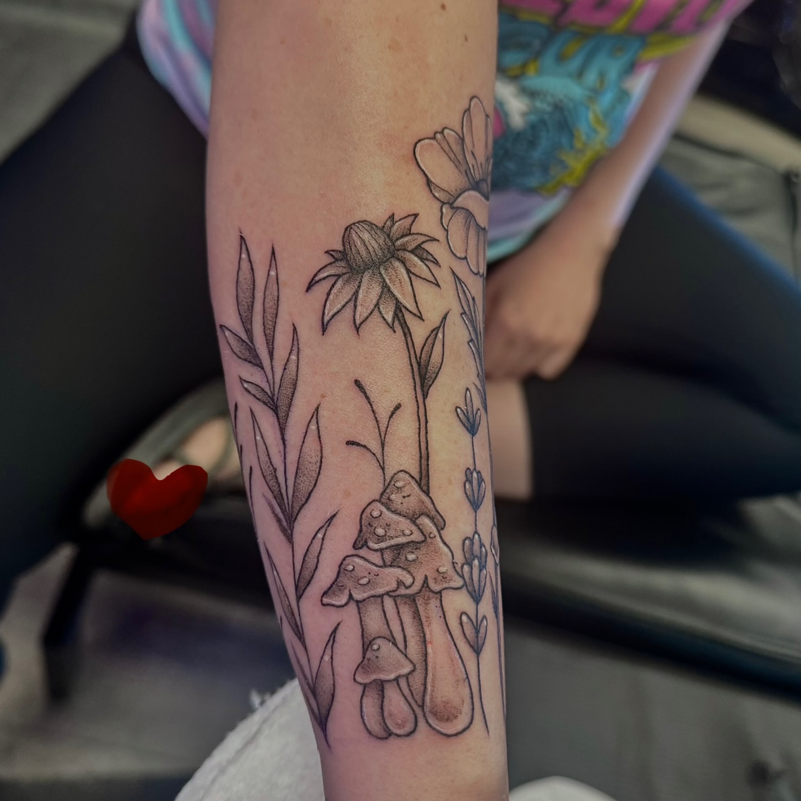 Mushroom and flowers black and grey tattoo on the forearm by Kat Bennett
