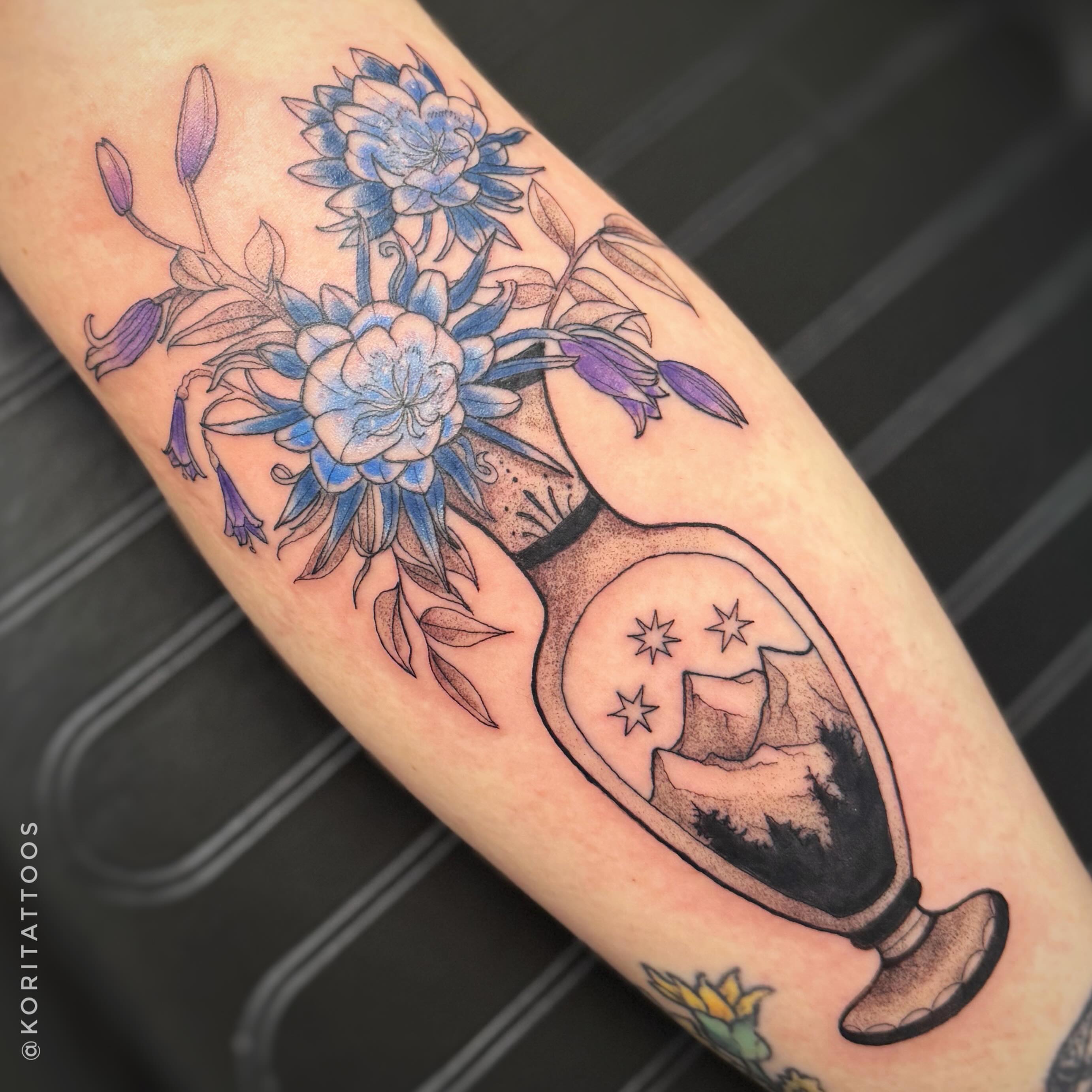 Flowers and hourglass dotwork tattoo on the forearm by Kori Millhimes