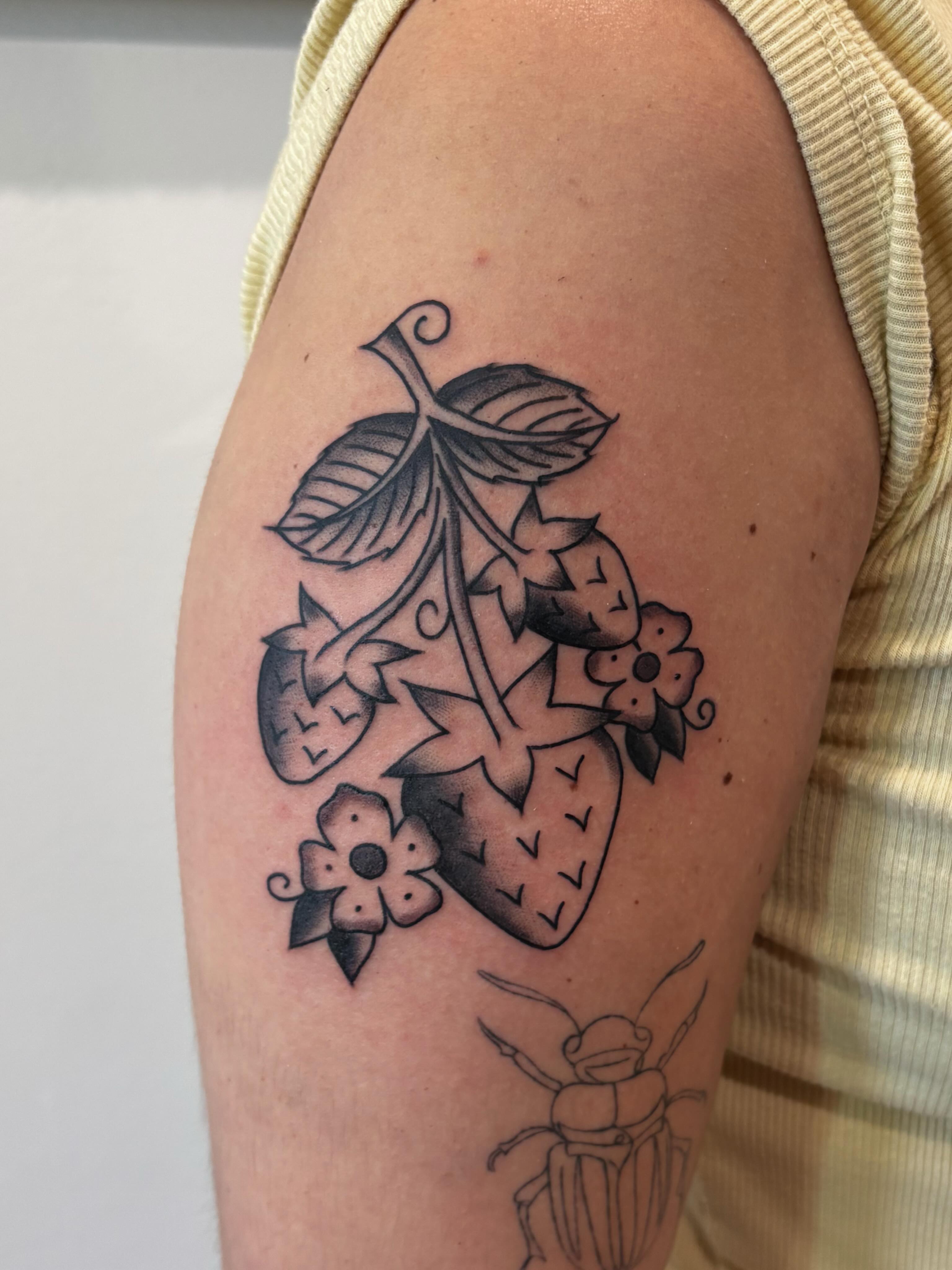 Strawberries and flowers black and grey tattoo on the upper arm by Evan Bisso, Philadelphia, Pennsylvania