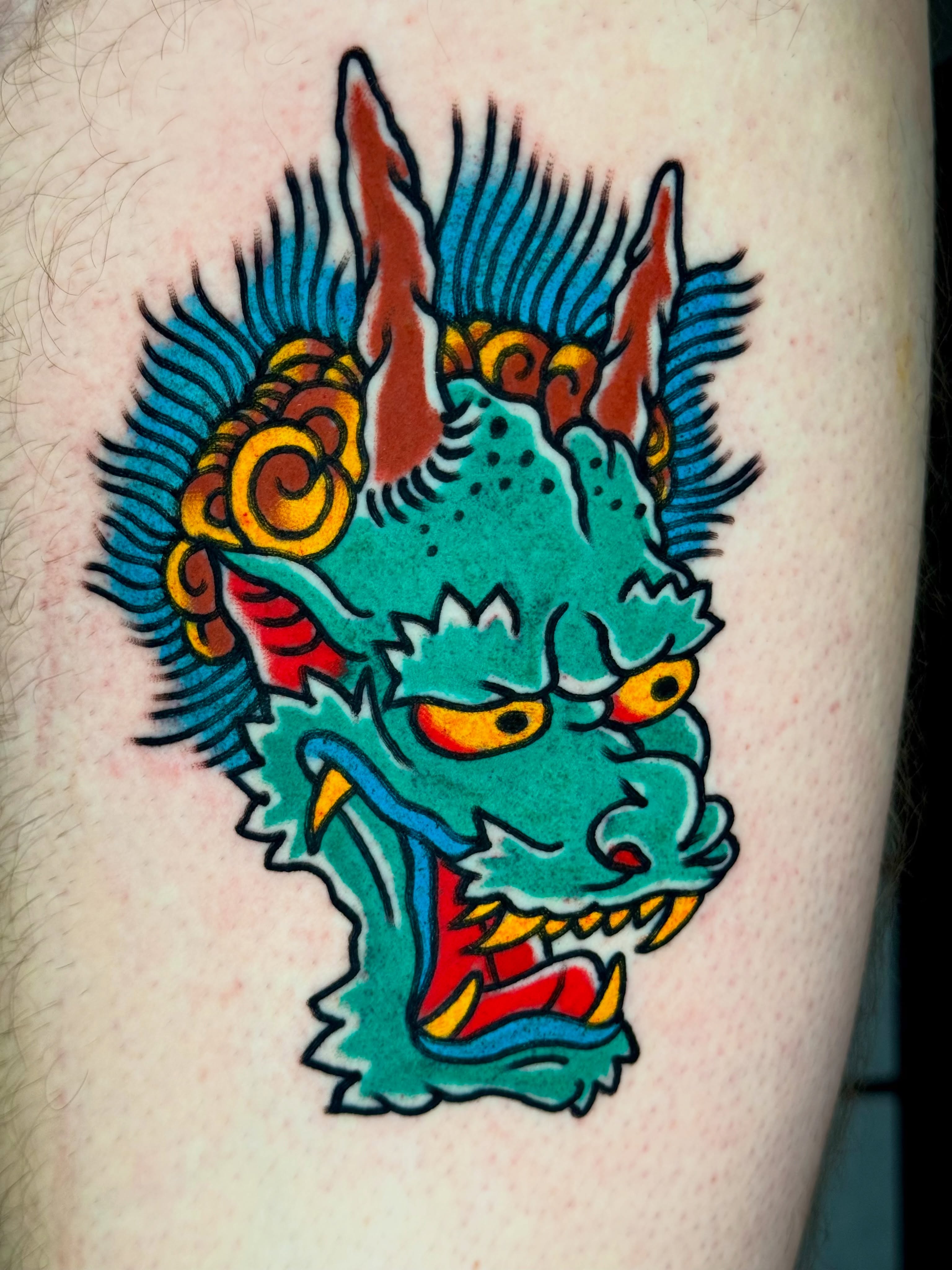 Dragon head American traditional tattoo on the thigh by Joe Bear Tattooer