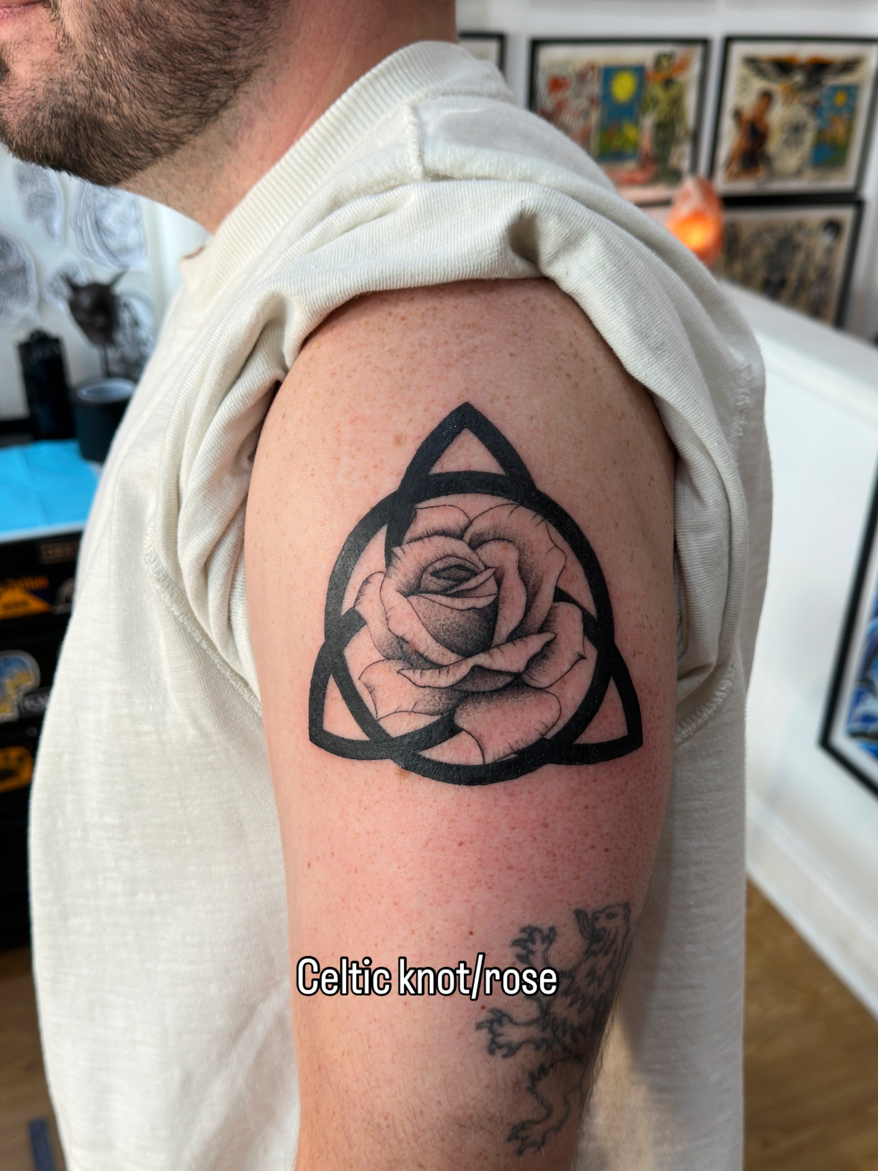 Celtic knot/rose black and grey tattoo on the upper arm by Matt Kearney