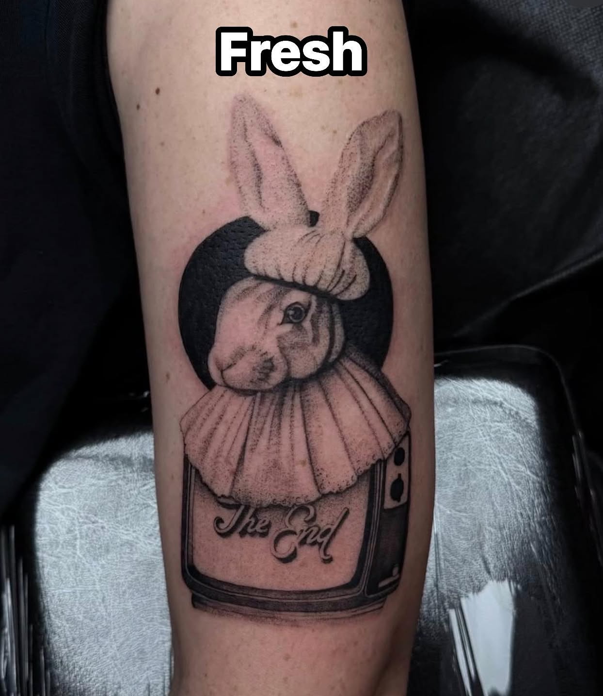 Rabbit in clown costume black and grey tattoo on the forearm by Madison Jasso