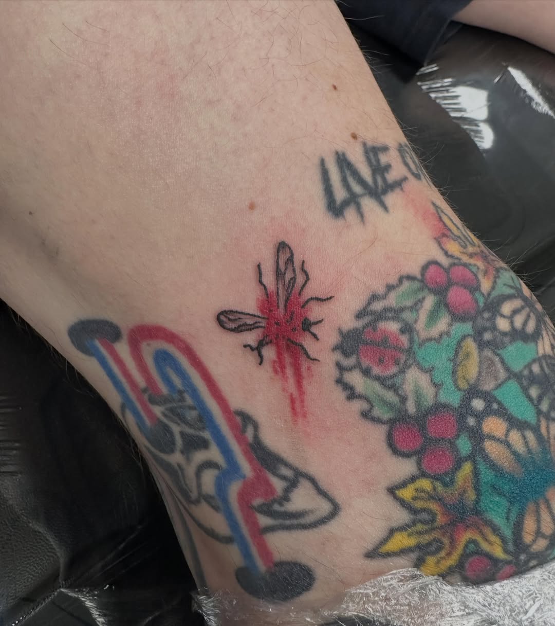 Bee and floral American traditional tattoo on the forearm by Nicki Hoverson