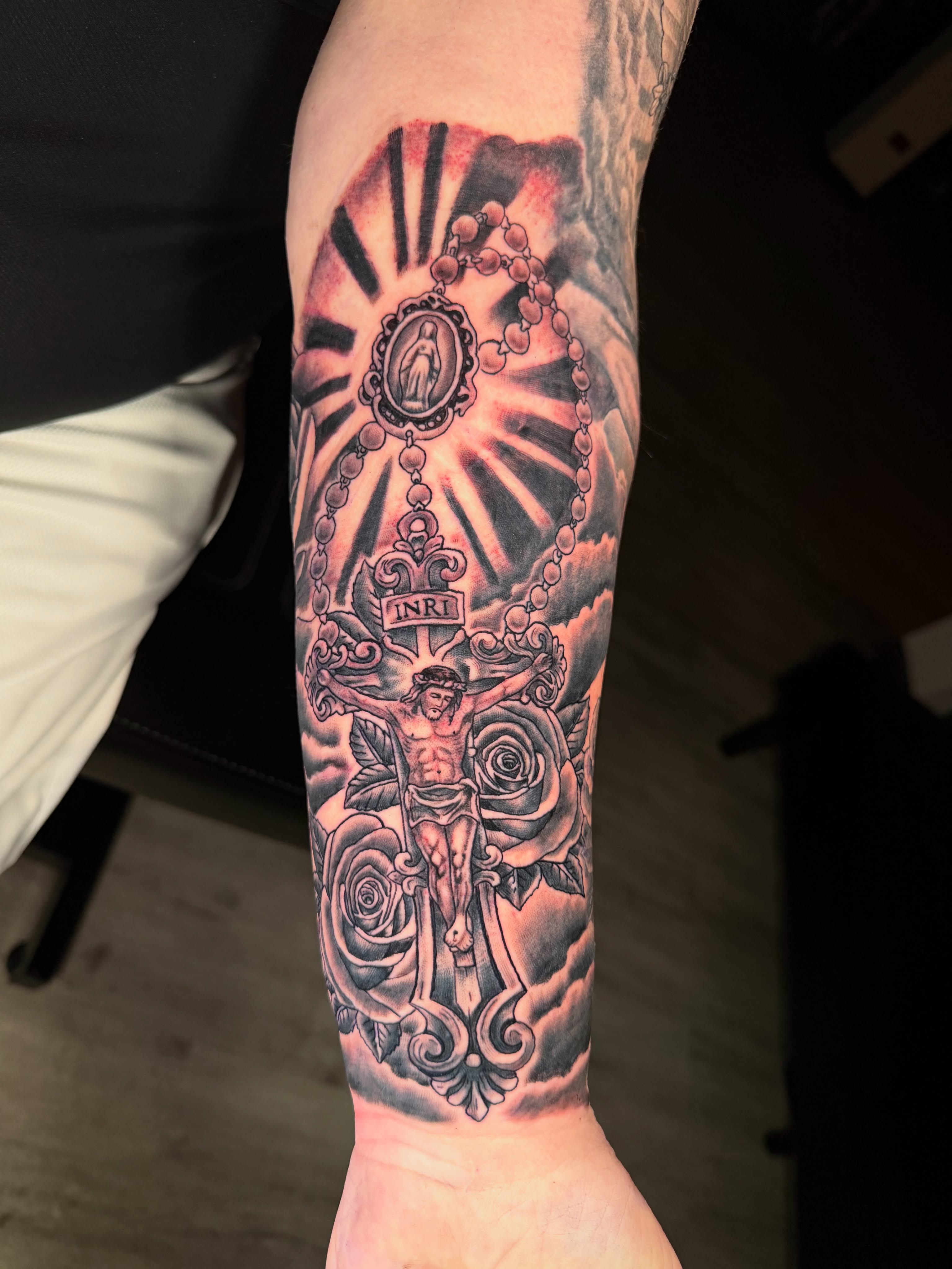 Religious crucifixion scene American traditional tattoo on the forearm by Beau Zeis