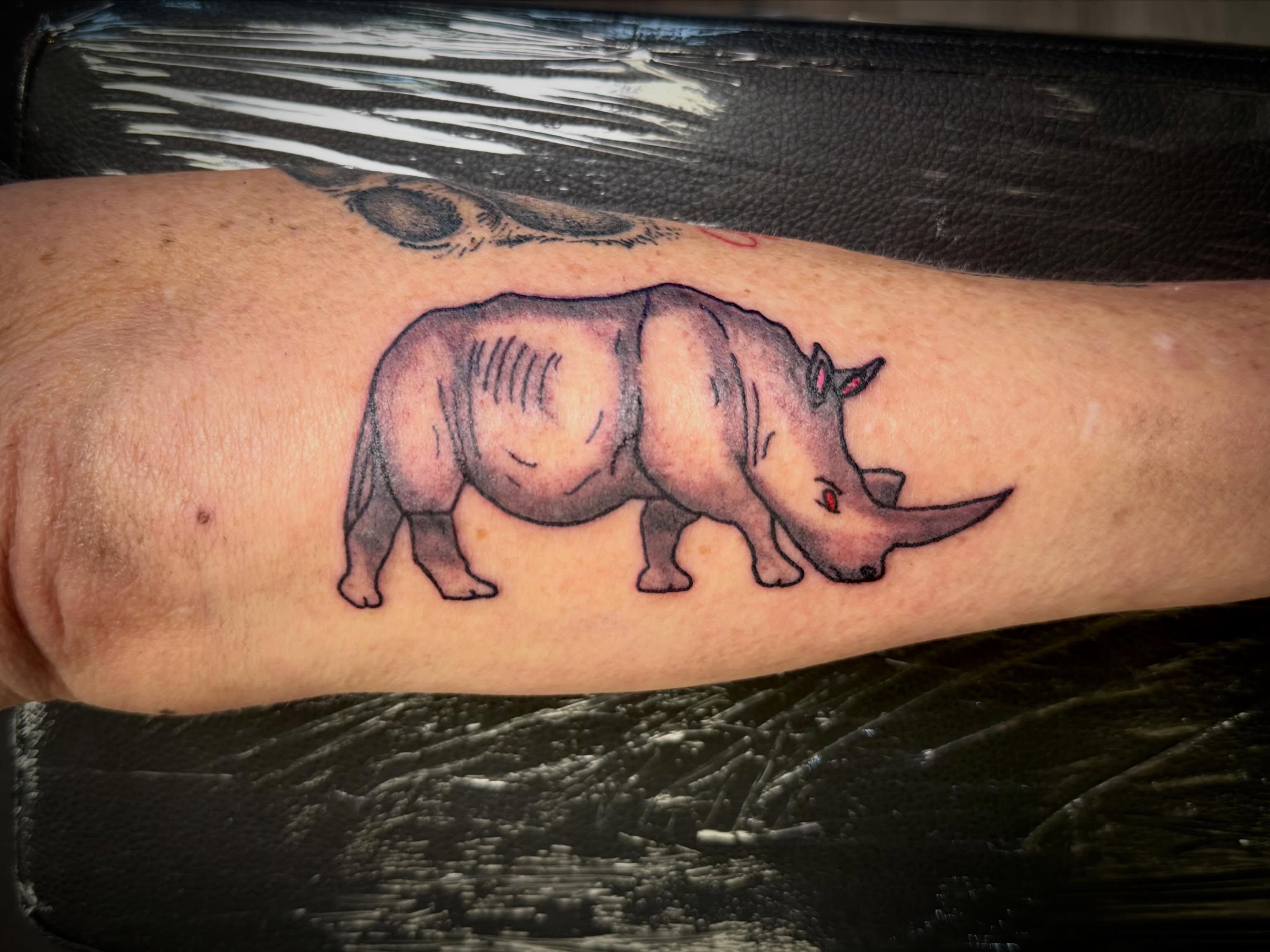 Rhino realism tattoo on the forearm by Mikey