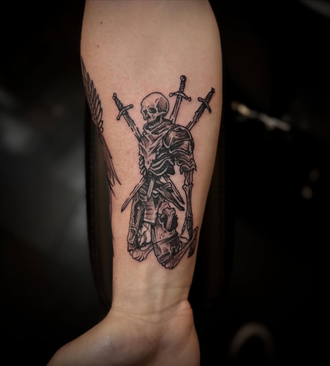 Skeleton with swords black and grey tattoo on the forearm by 𝕽𝖎𝖌𝖊𝖗𝖘 𝕳𝖆𝖒𝖟𝖆, San Francisco, California