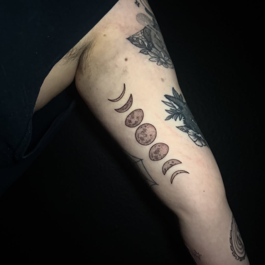 Moon phases black and grey tattoo on the forearm by Lauren B