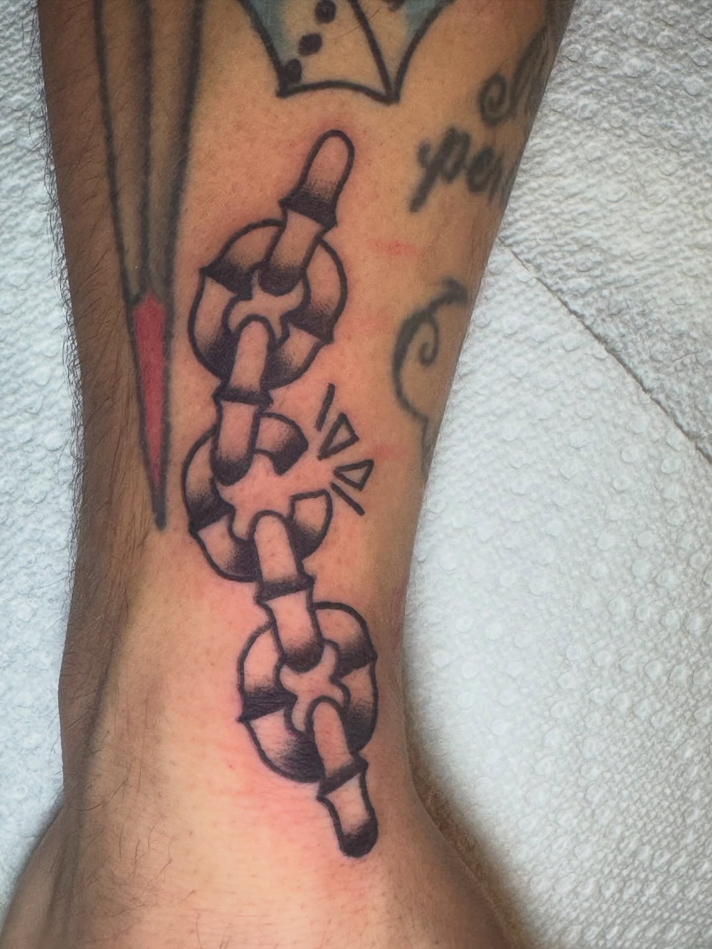 Chain American traditional tattoo on the forearm by Kenneth Gibson