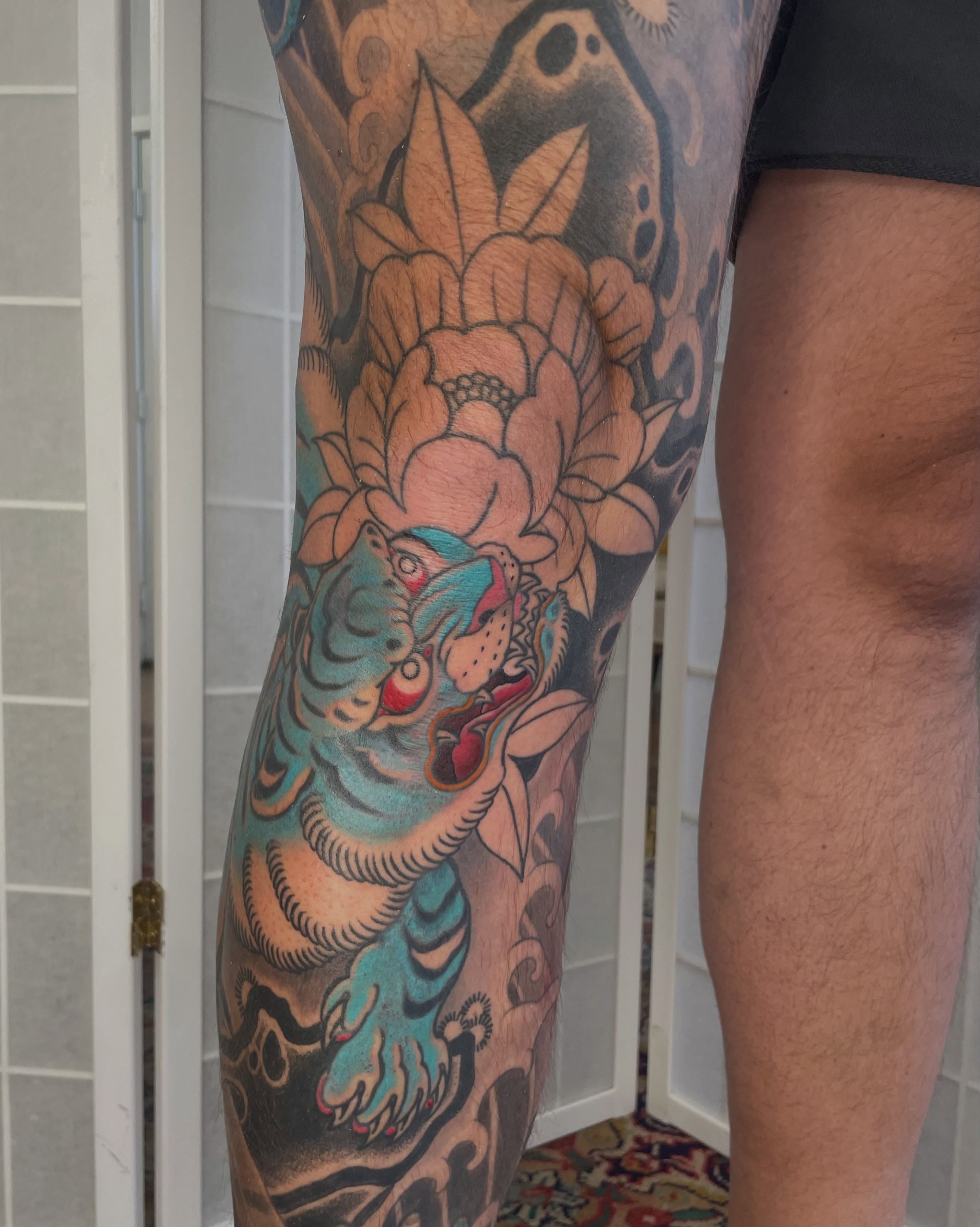Tiger and lotus American traditional tattoo on the leg by Collie Mills, Philadelphia, Pennsylvania