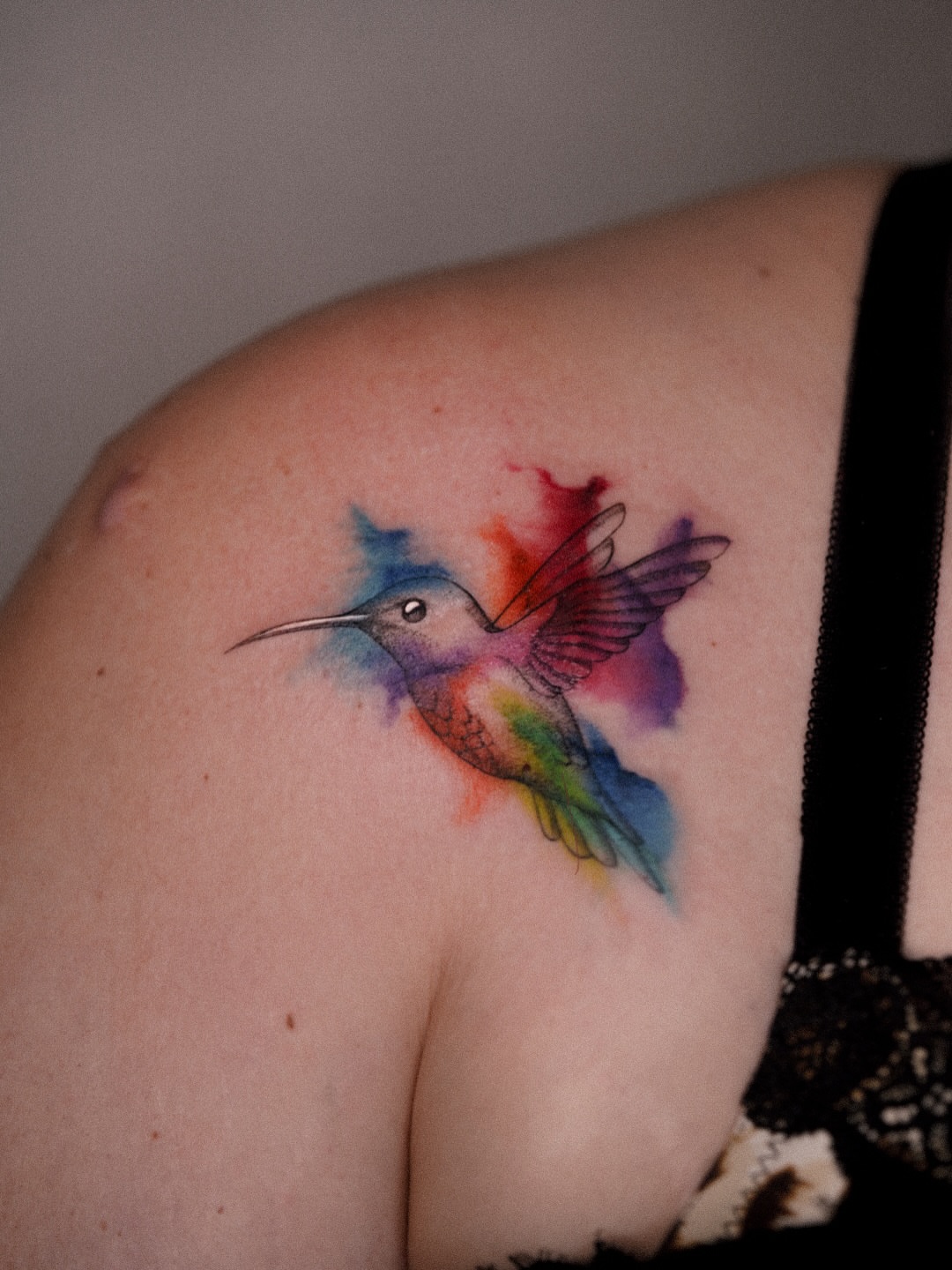 Hummingbird watercolor tattoo on the shoulder by Joy Christiana