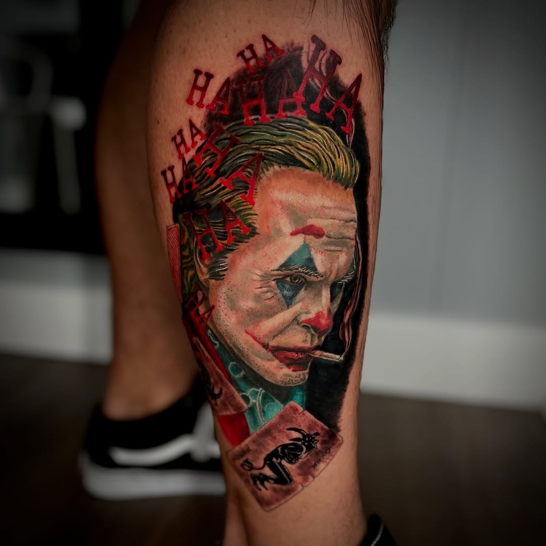 Joker portrait with playing cards realism tattoo on the forearm by Justin Rivera