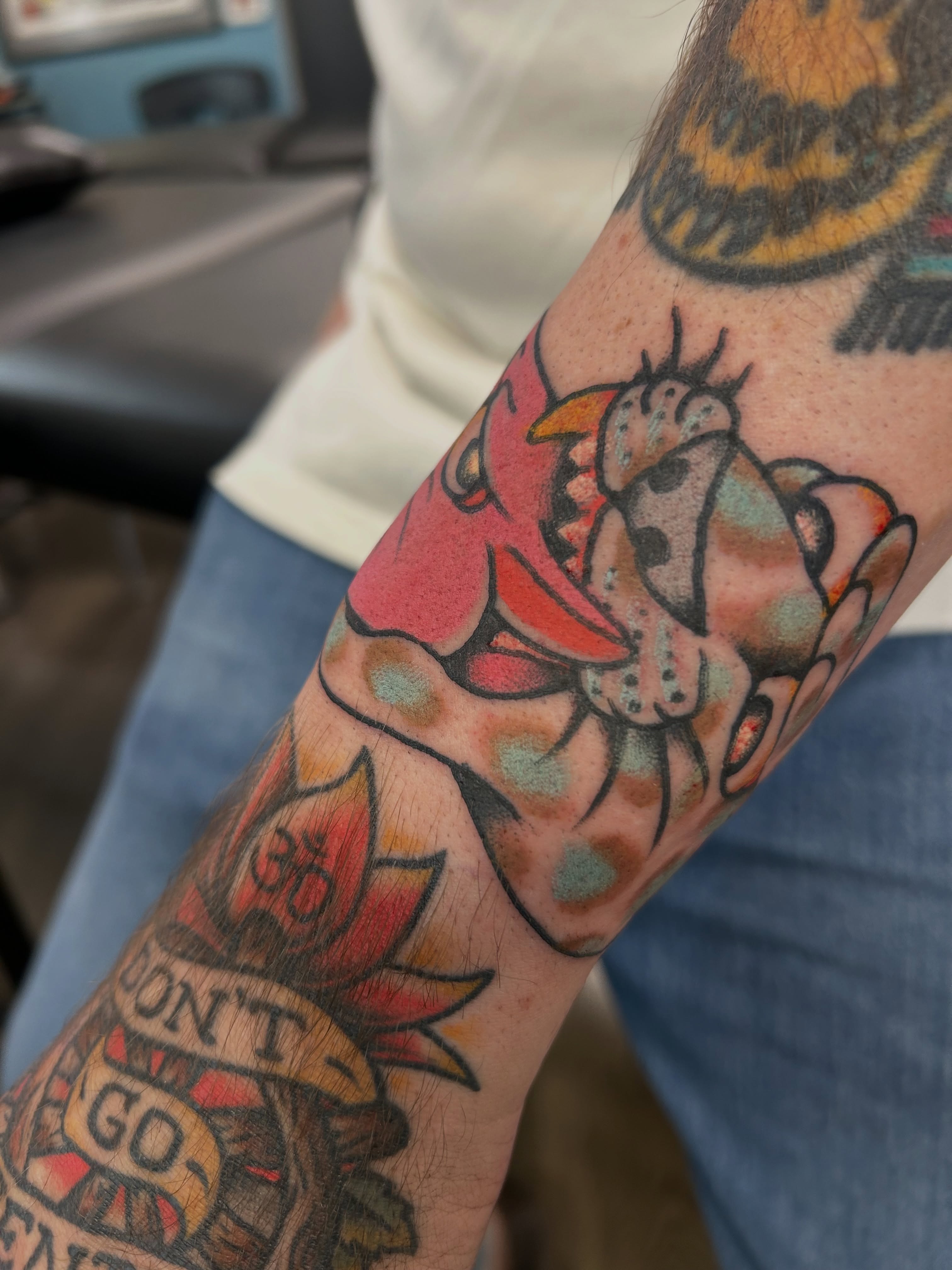 Cow and heart American traditional tattoo on the forearm by Mike "Yogi" Trube