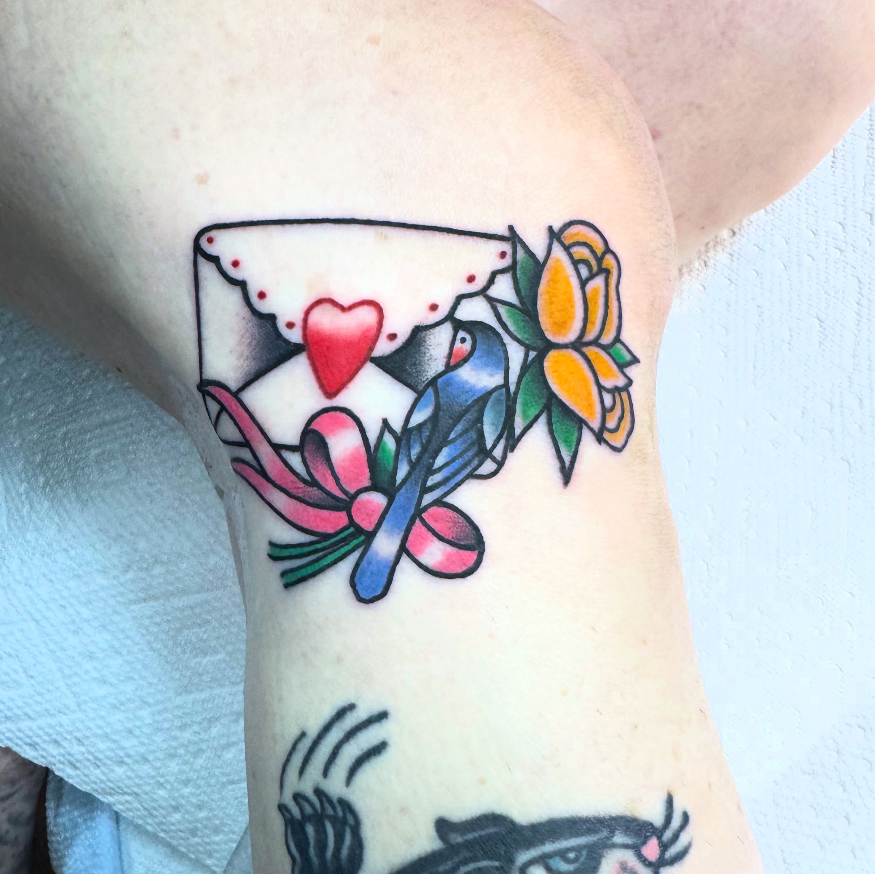 Love letter and bird American traditional tattoo on the forearm by Lisa Del Toro