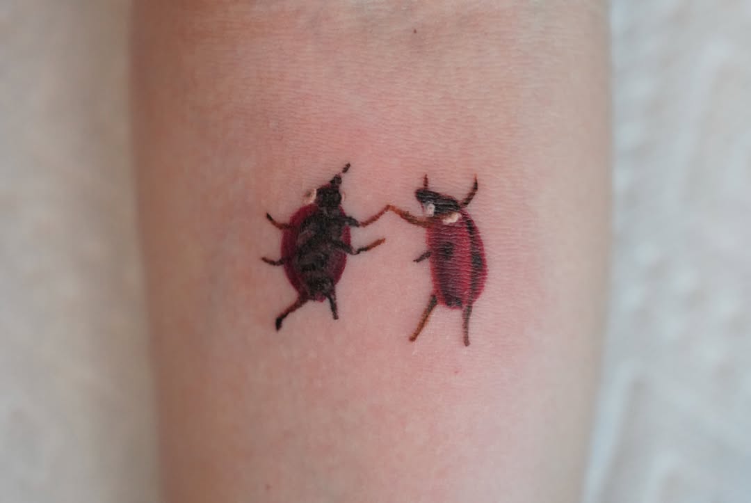 Ladybugs dotwork tattoo on the forearm by Jaiden Ducoff