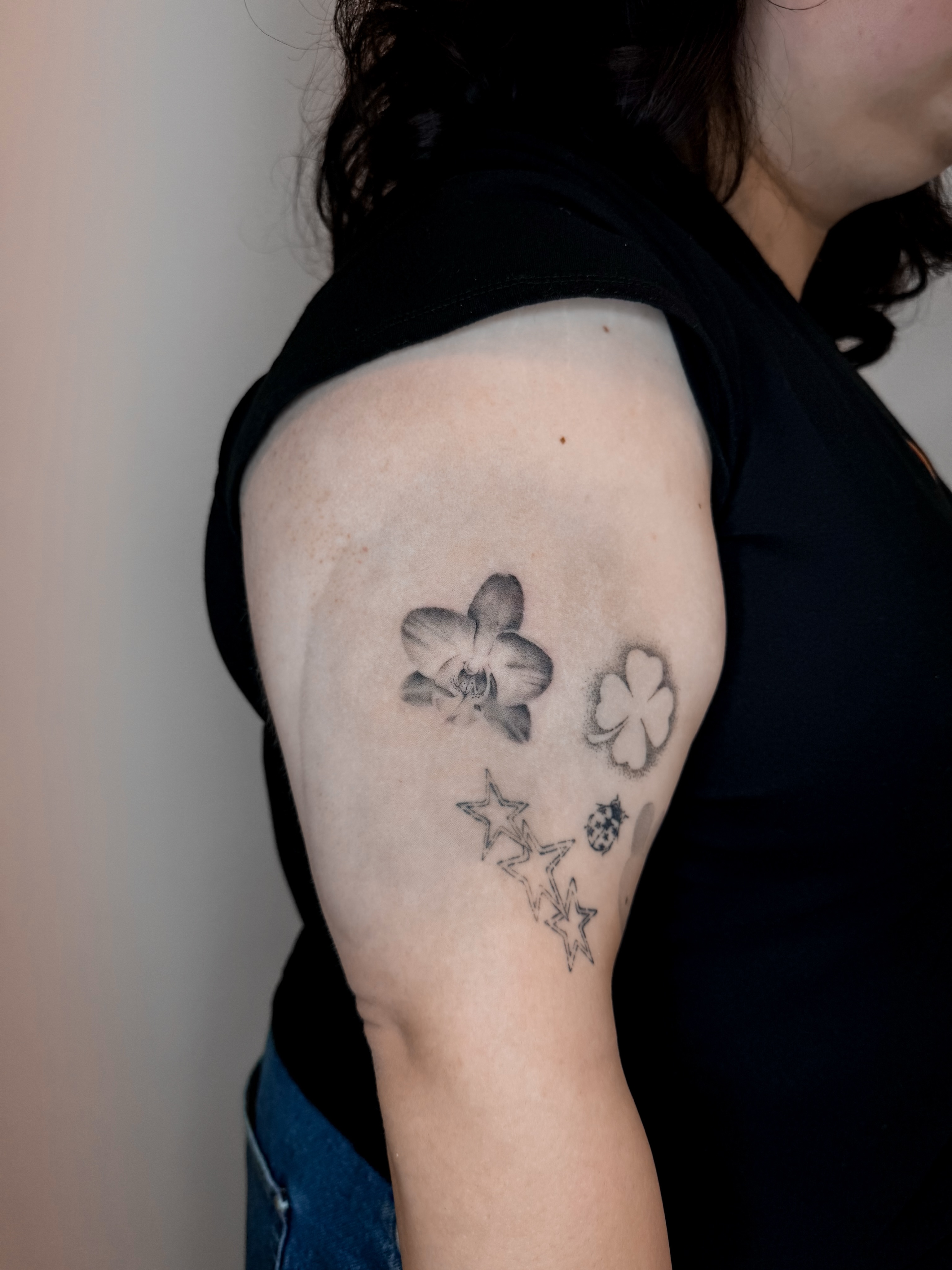 Orchid and clover black and grey tattoo on the shoulder by Rylee