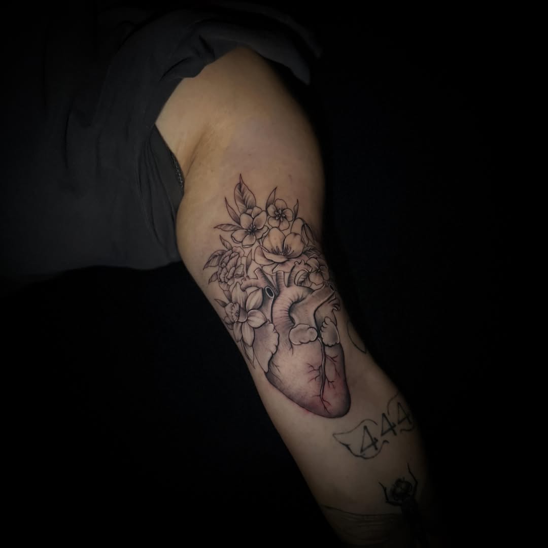 Heart with flowers black and grey tattoo on the forearm by Sad Girl Tattoos