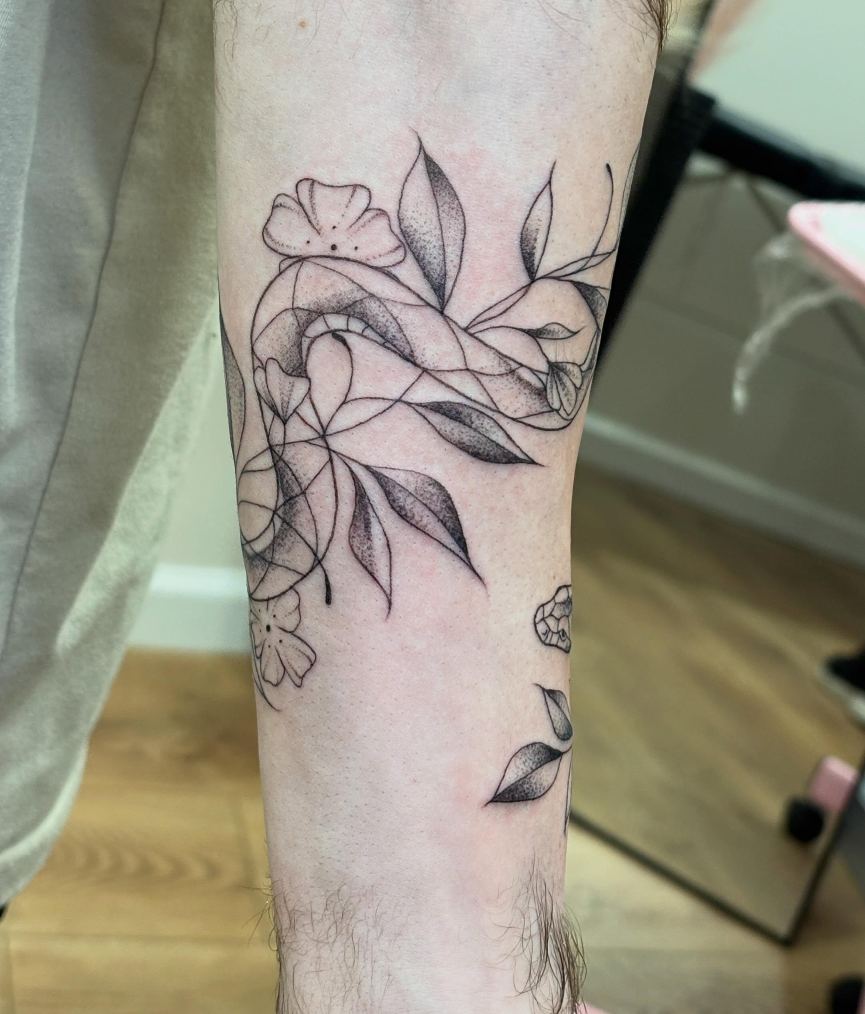 Floral design dotwork tattoo on the forearm by Kendra Parkis
