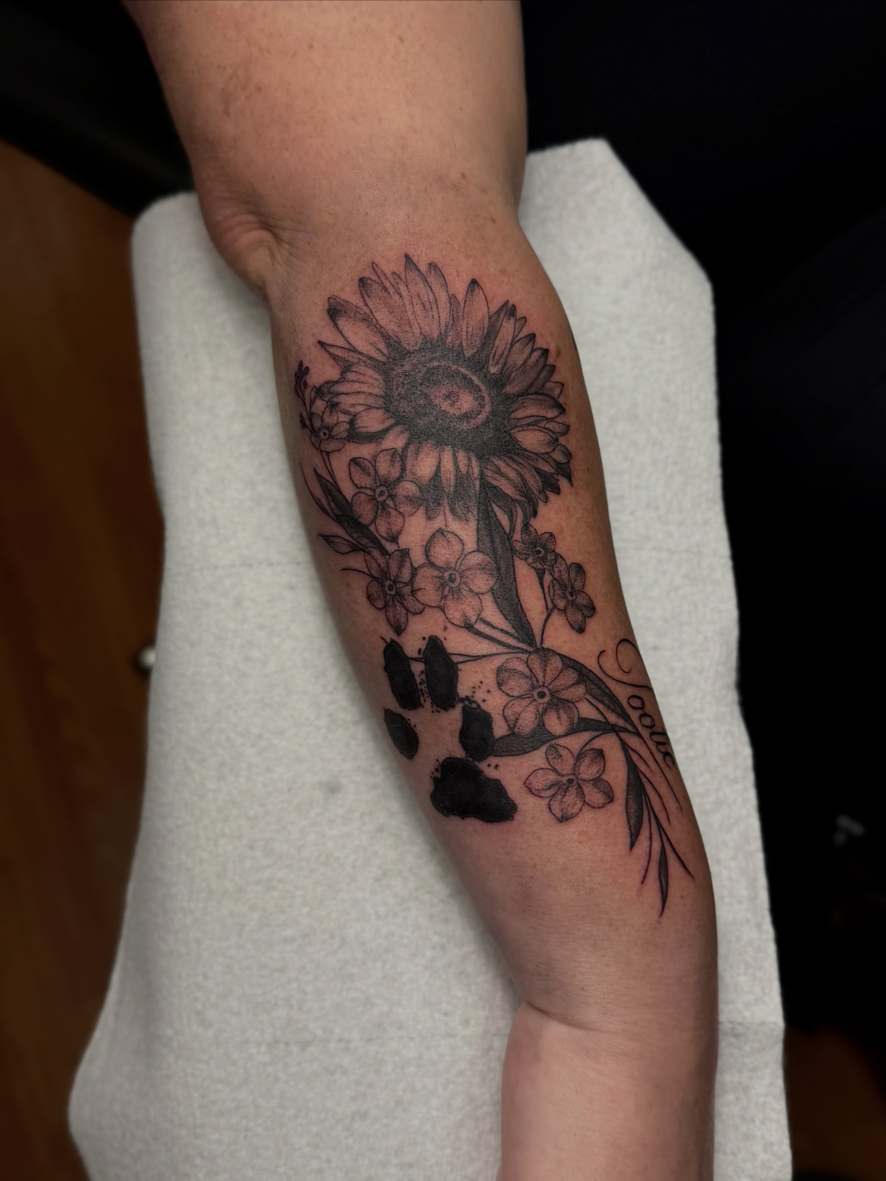 Sunflower bouquet black and grey tattoo on the forearm by Skylar Sheeley