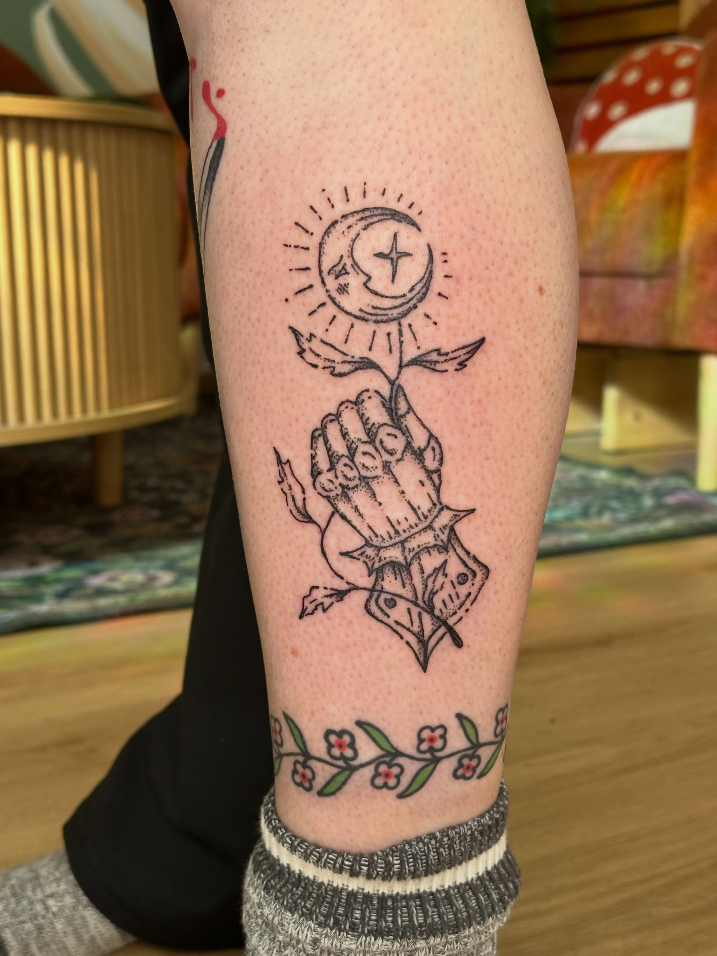 Praying hand with sun and moon black and grey tattoo on the forearm by Fleur ๐ฅ